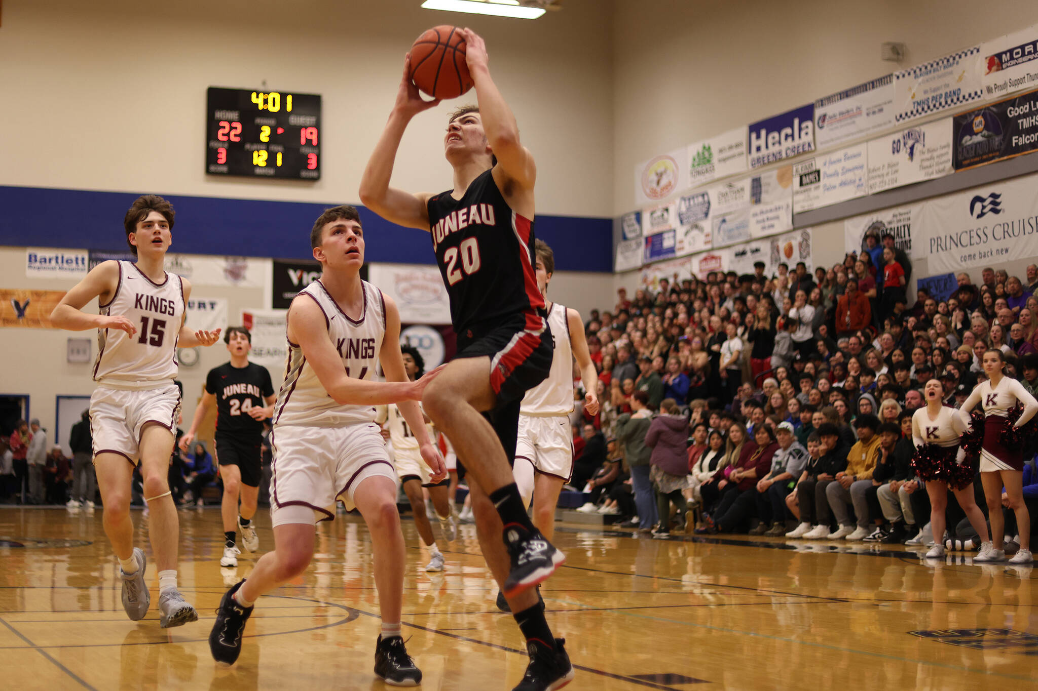 JDHS senior Orion Dybdahl begins ascending for a dunk with Kayhi’s Jared Rhoads (15) and Marcus Stockhausen (34) in pursuit. Orion was named Player of the Game and led his team in scoring on Friday against Colony High School in this year’s state competition in Anchorage. (Ben Hohenstatt / Juneau Empire File)