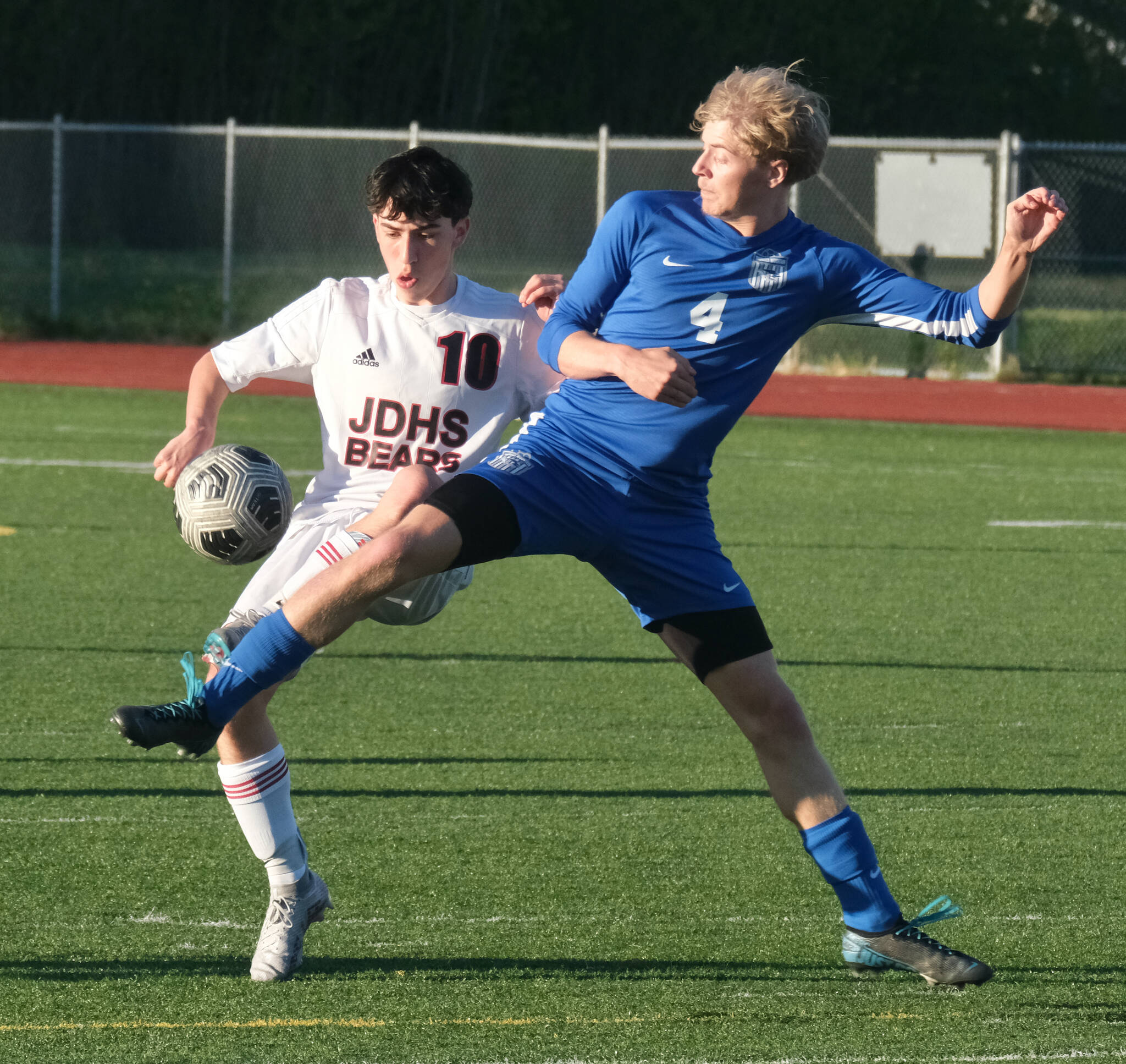 JDHS sophomore Kellen Chester (10) and TMHS senior Matthew Spratt (4) battle for a ball during the Crimson Bears 6-1 win over the Falcons Tuesday at Falcons Field. (Klas Stolpe / Juneau Empire)