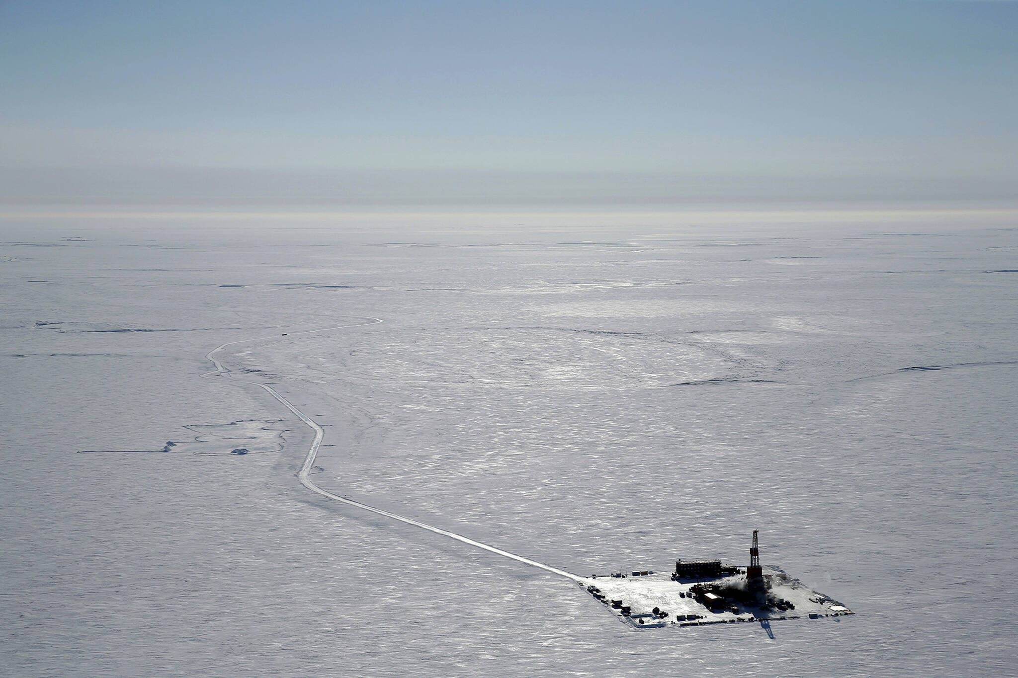 This 2019 aerial photo provided by ConocoPhillips shows an exploratory drilling camp at the proposed site of the Willow oil project on Alaska's North Slope. Alaska's push to become a bigger player in the clean energy market is in the spotlight this week at a conference convened by Republican Gov. Mike Dunleavy, even as the state continues to embrace new fossil fuel production, including the controversial Willow oil project.   (ConocoPhillips)
