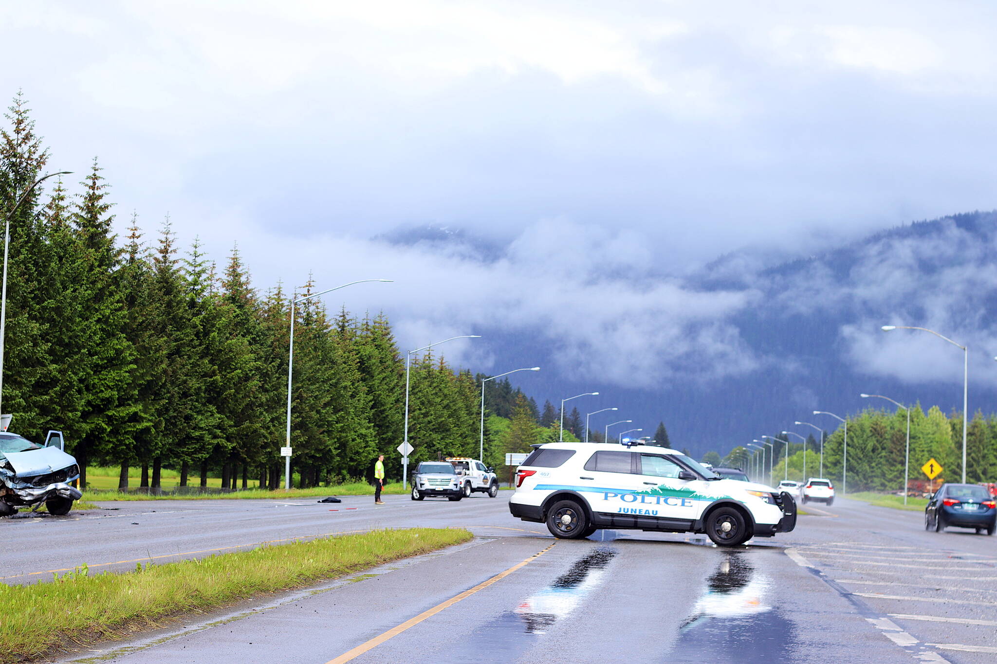 A police vehicle blocks the left turn lane from Egan Drive into Yandukin Drive on Saturday after a two-vehicle collision killed one person and seriously injured four others. Changes intended to improve drivers’ line of sight when making left turns on both sides of Egan Drive are scheduled to be complete by October. But state officials said Monday more significant changes recommended in a 2021 study, including a traffic signal and an alternative detour lane, are still on hold and will likely take a long time to get through the regulatory process. (Clarise Larson / Juneau Empire)