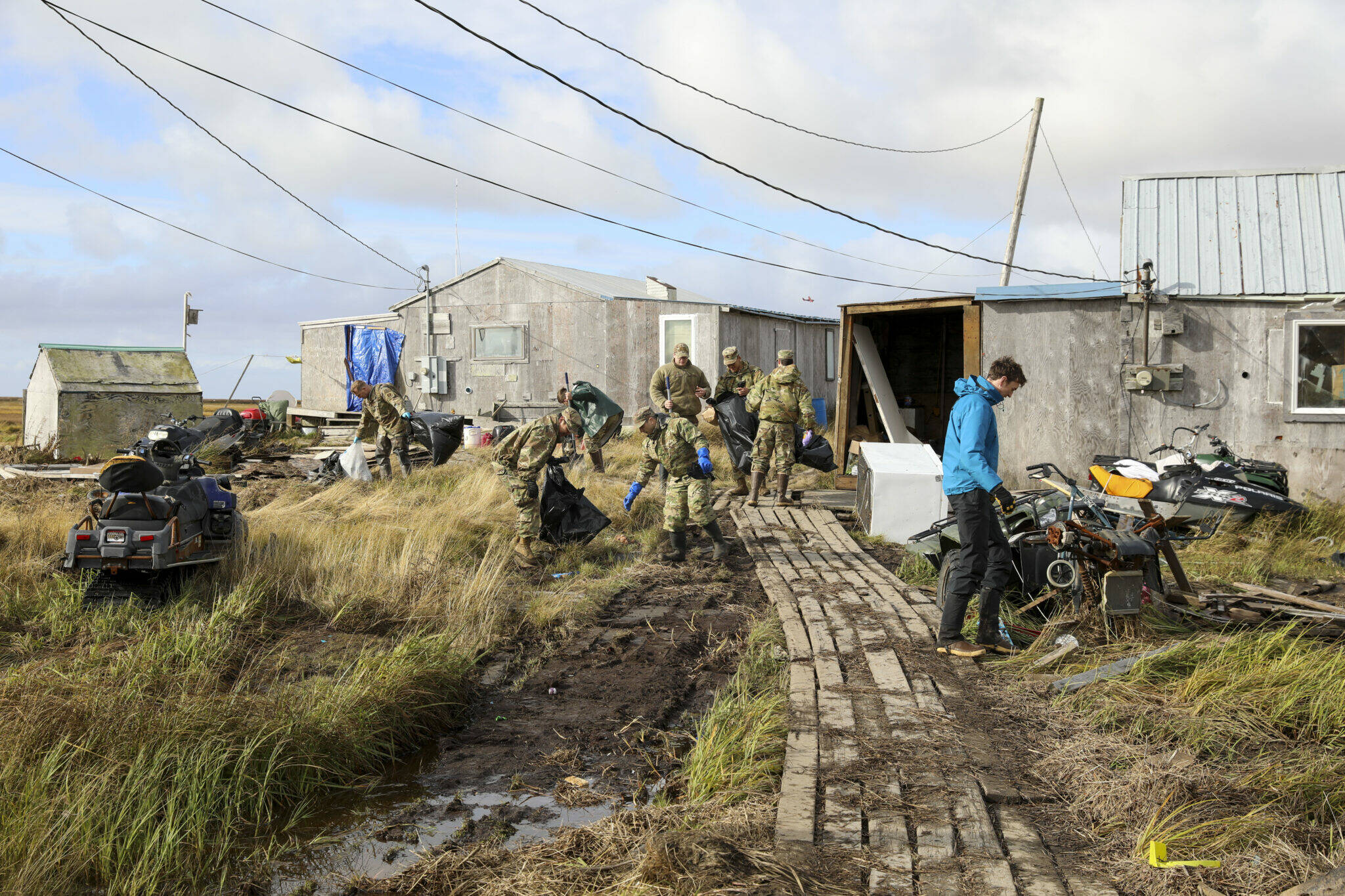 Alaska National Guardsmen assigned to Joint Task Force – Bethel clear storm debris in Newtok, Alaska, as part of Operation Merbok Response, Sept. 22, 2022. Approximately 100 members of the Alaska Organized Militia, which includes members of the Alaska National Guard, Alaska State Defense Force and Alaska Naval Militia, were activated following a disaster declaration issued Sept. 17 after the remnants of Typhoon Merbok caused dramatic flooding across more than 1,000 miles of Alaskan coastline. (Alaska National Guard photo by 1st Lt. Balinda O’Neal)