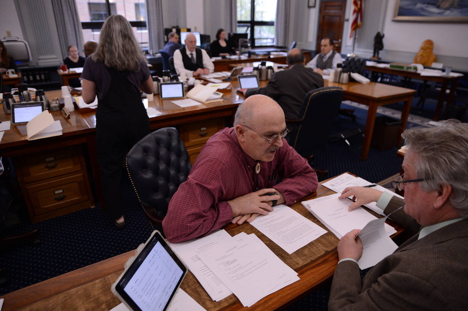 Sen. Click Bishop, R-Fairbanks, talks to an aide during a break in a Senate Finance Committee meeting on Sunday. (James Brooks/Alaska Beacon)