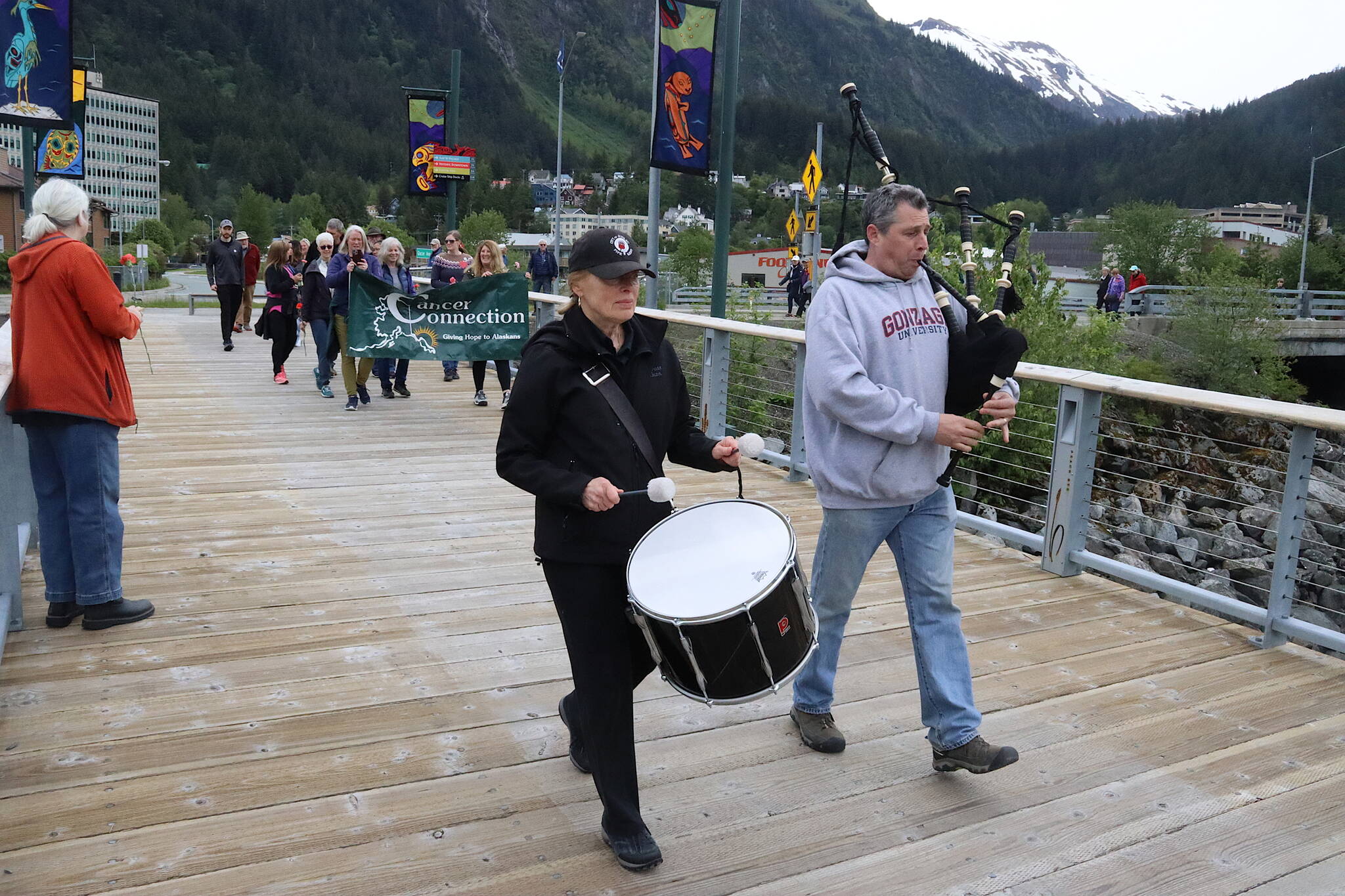 City of Juneau Pipe Band members Sue Behnert and Scott Mornon lead participants along the downtown Juneau waterfront to Bill Overstreet Park during the annual Celebration of Life Walk on Sunday, June 2, which is National Cancer Survivors Day. (Mark Sabbatini / Juneau Empire)