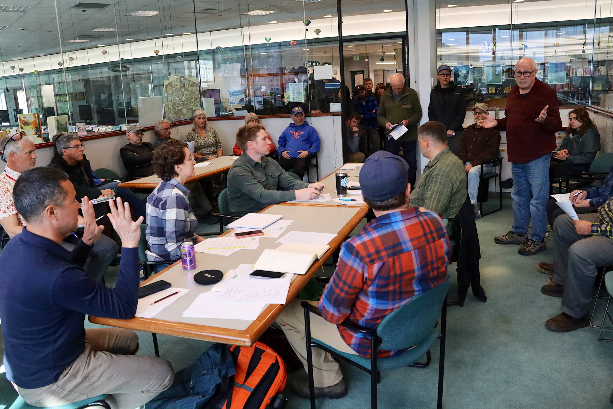 Juneau residents, including many current and former employees and leaders at Eaglecrest Ski Area, pack a room at the downtown public library for a meeting of the resort’s board of directors Thursday night. (Mark Sabbatini / Juneau Empire)