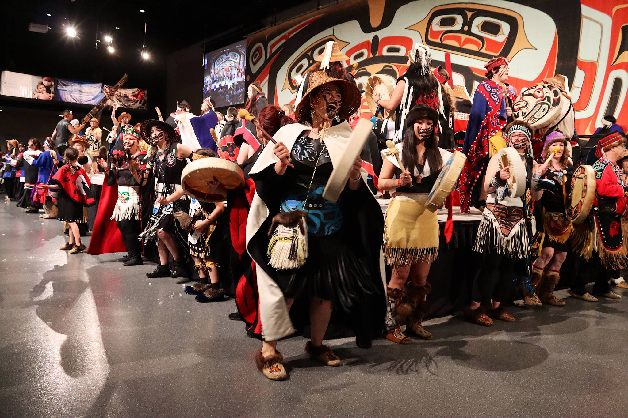 Celebration 2024 participants dance across and around the main stage at Centennial Hall during the Grand Exit ceremony Saturday evening. (Mark Sabbatini / Juneau Empire)