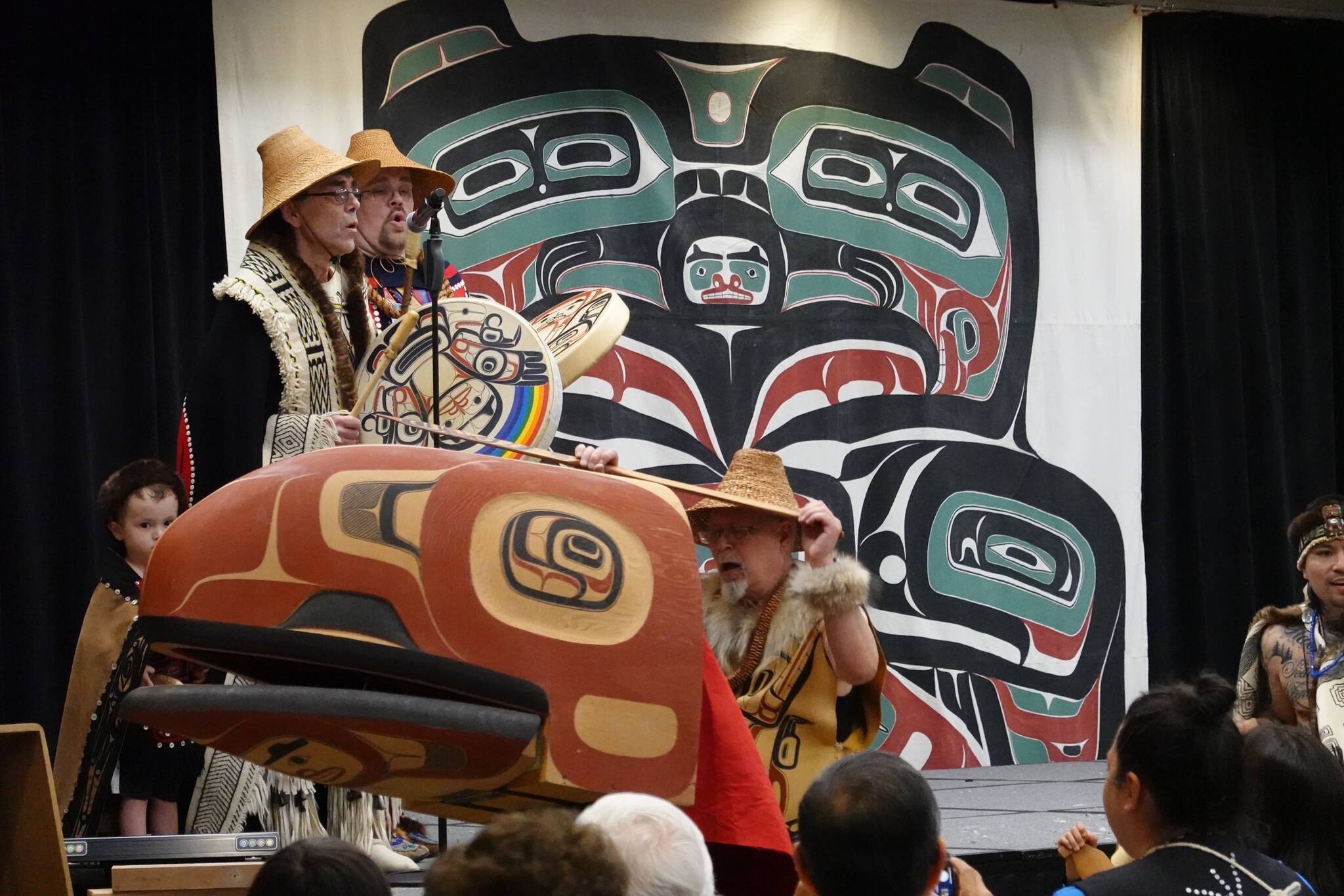 David A. Boxley, wearing a Ravenstail-trimmed robe, and his son David R. Boxley sing and drum in Elizabeth Peratrovich Hall on Saturday afternoon as Metlakatla’s Git Hoan dancers perform a canoe paddling dance featuring a large carved headdress created by Git Hoan’s senior Boxley. (Laurie Craig / Juneau Empire)