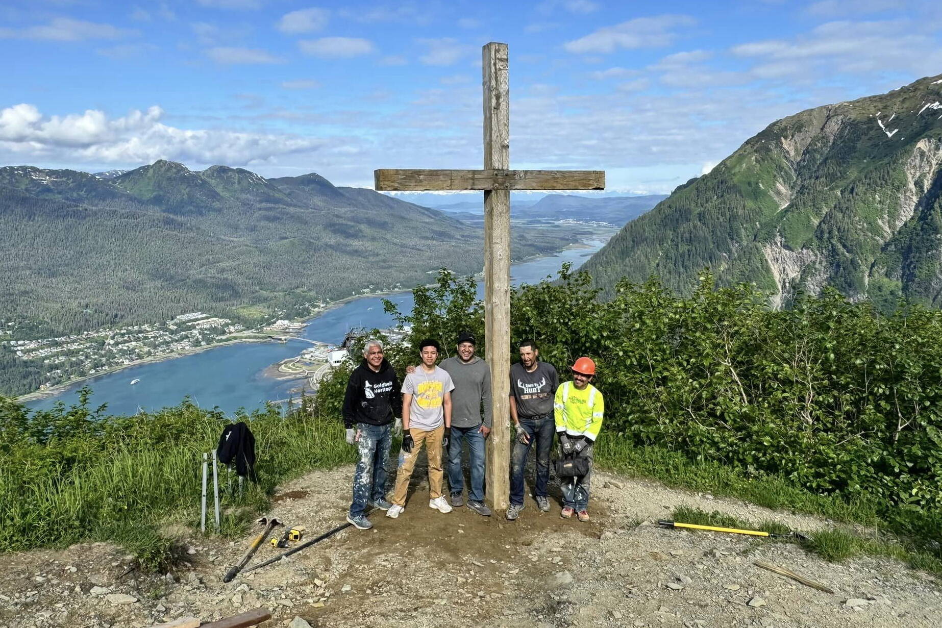 Workers stand next to the Father Brown’s Cross after they reinstalled it at an overlook site on Mount Roberts on Wednesday. (Photo courtesy of Hugo Miramontes)