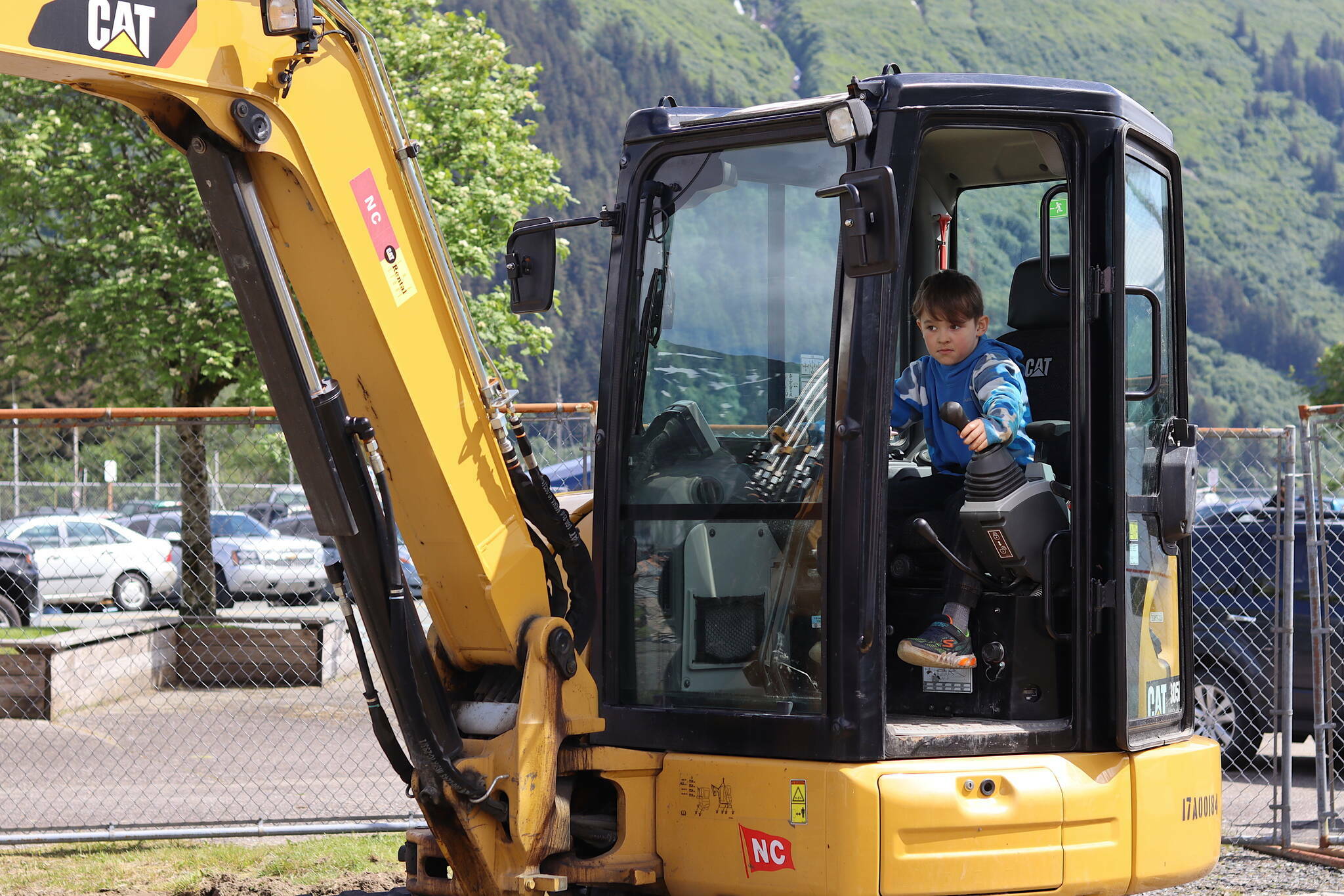 James Whistler, 8, operates a mini excavator during Gold Rush Days on Saturday, June 17, 2023. People young and old were offered a chance to place tires around traffic cones and other challenges after getting a brief introduction to the excavator. (Mark Sabbatini / Juneau Empire file photo)