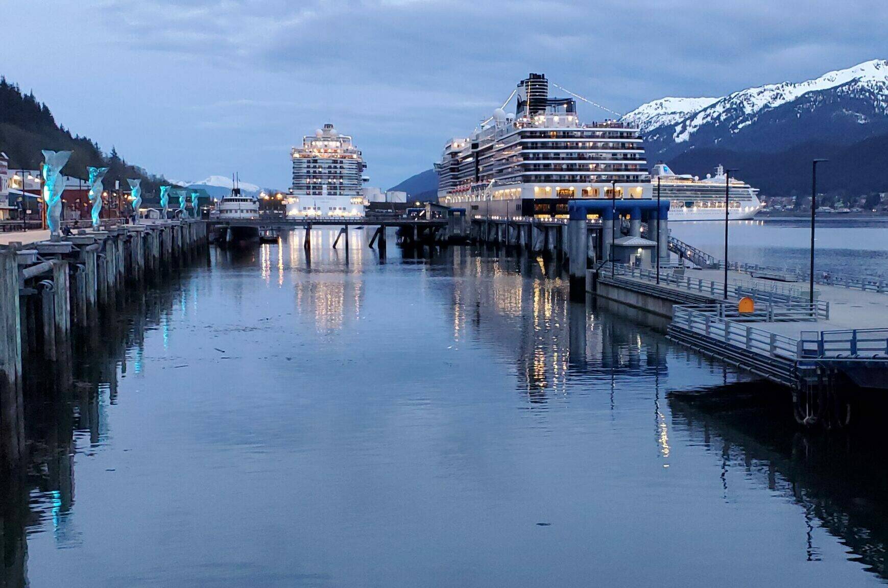 Three cruise ships are docked along Juneau’s waterfront on the evening on May 10, as a Princess cruise ship on the right is departing the capital city. (Yereth Rosen/Alaska Beacon)