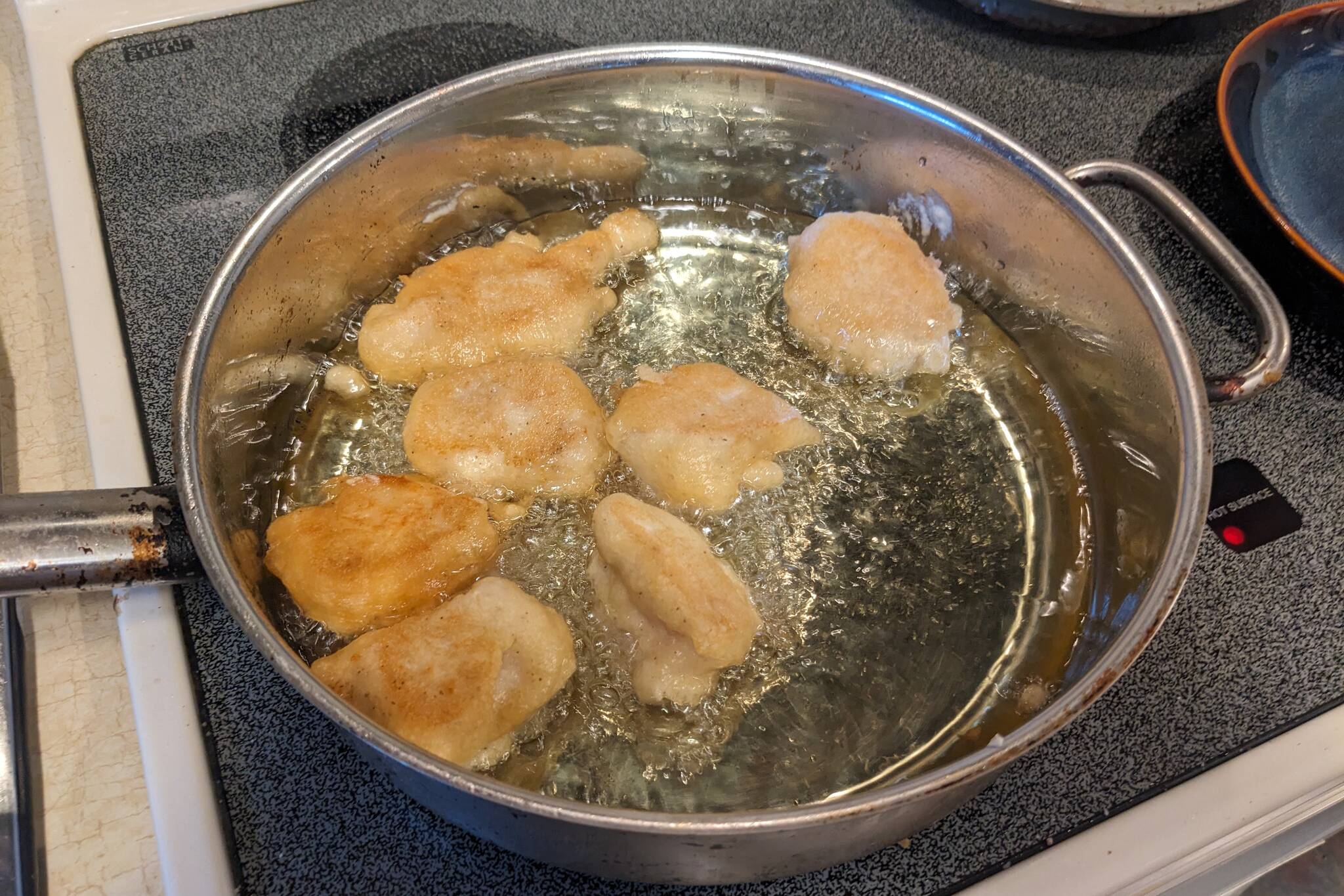 Battered fish fillets frying. (Photo by Patty Schied)