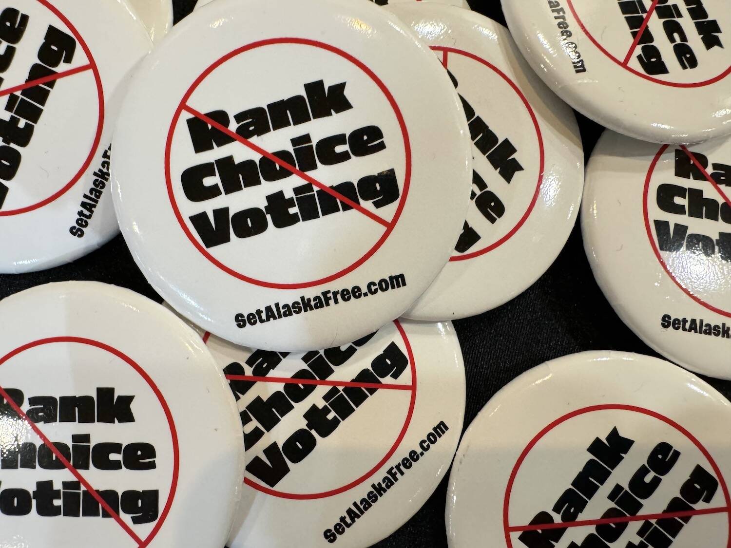 Pins supporting the repeal of ranked choice voting are seen on April 20 at the Republican state convention in Anchorage. (James Brooks/Alaska Beacon)