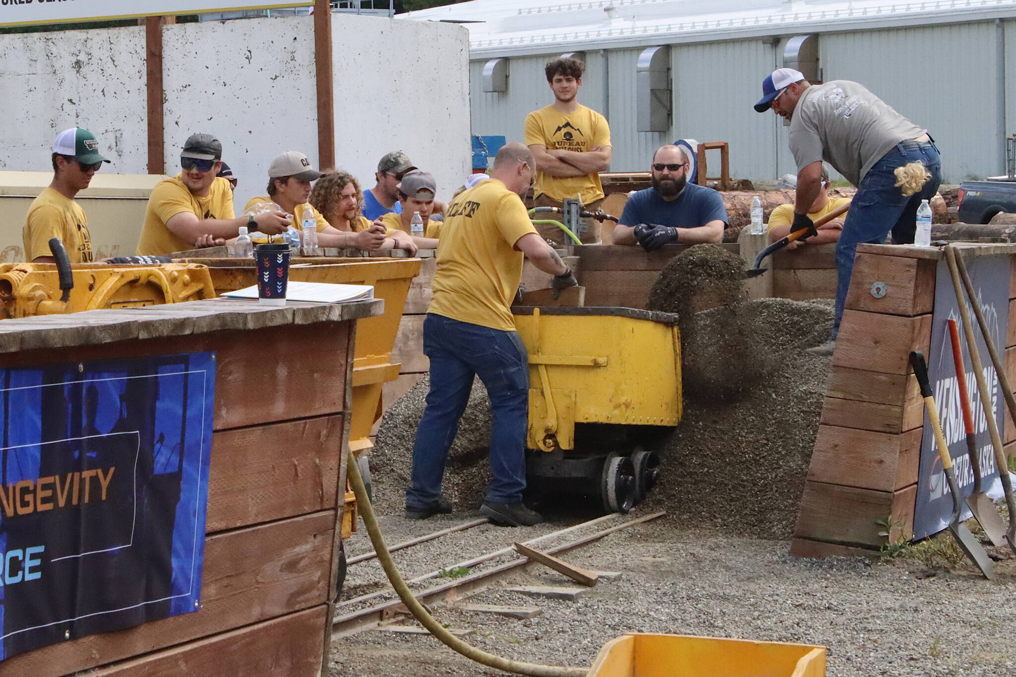 Eddie Petrie shovels gravel into a mine cart as fast as possible during the men’s hand mucking competition as part of Juneau Gold Rush Days on Saturday at Savikko Park. (Mark Sabbatini / Juneau Empire)