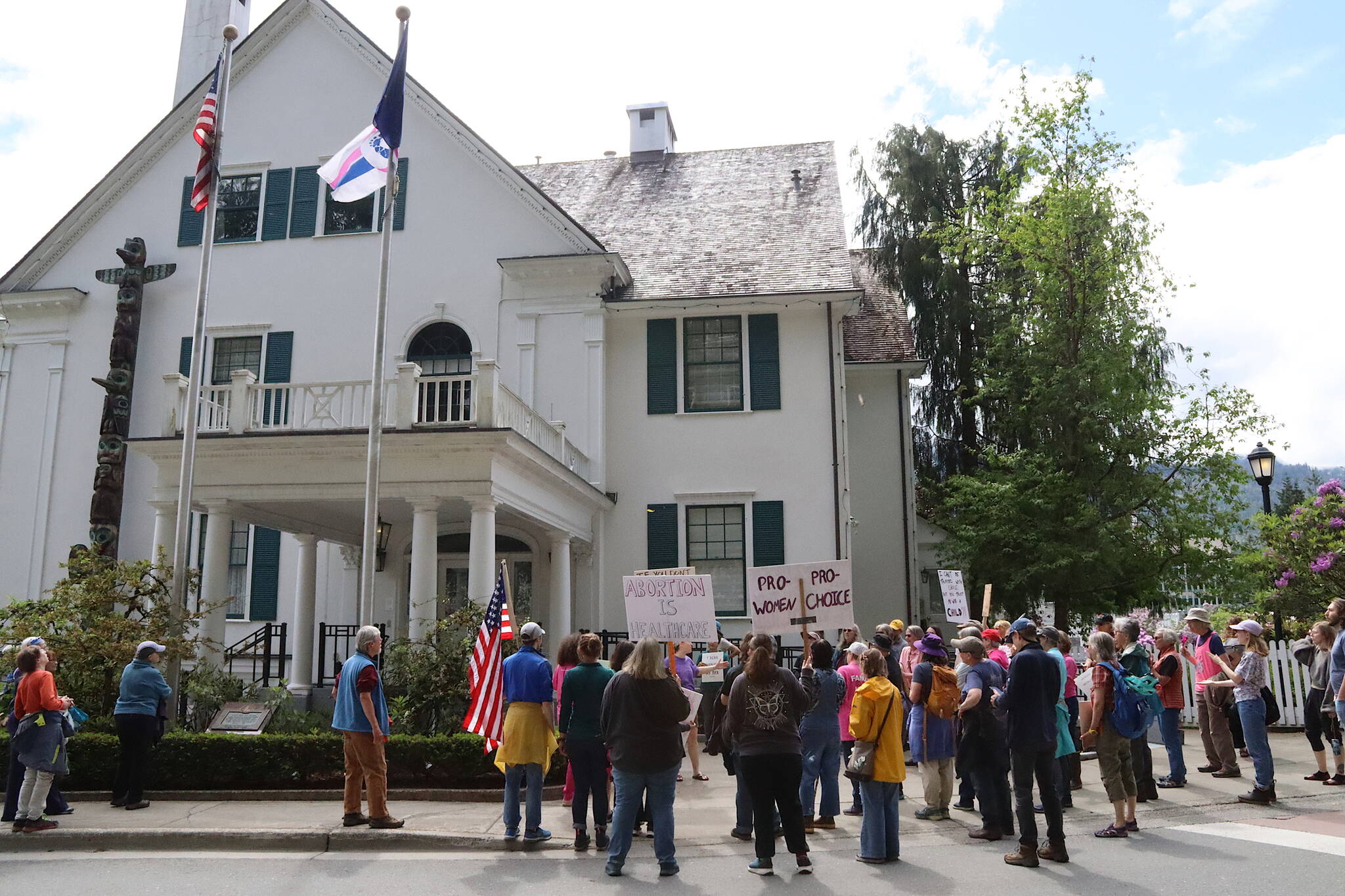 Participants in a pro-choice abortion rally gather outside the Governor’s Residence on Saturday to demand a pro-life flag flying at the entrance be taken down. (Mark Sabbatini / Juneau Empire)
