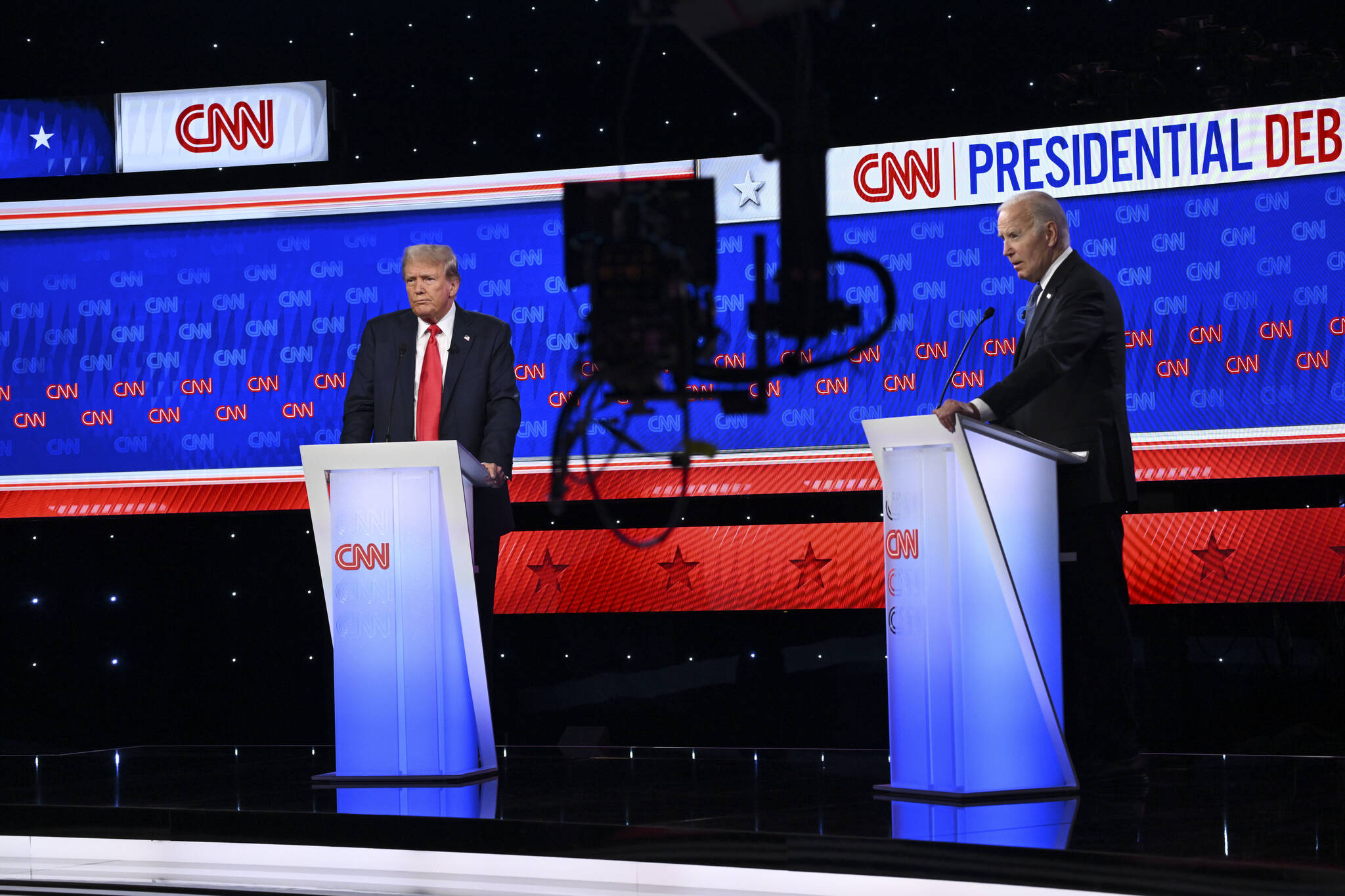 Former President Donald Trump and President Joe Biden listen to the moderators during the first 2024 presidential election debate at CNN’s headquarters in Atlanta on Thursday. (Kenny Holston/The New York Times)