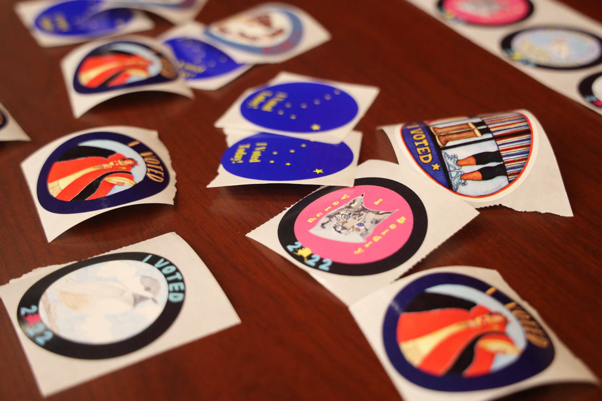 An array of stickers awaits voters on Election Day 2022. (Clarise Larson / Juneau Empire file photo)