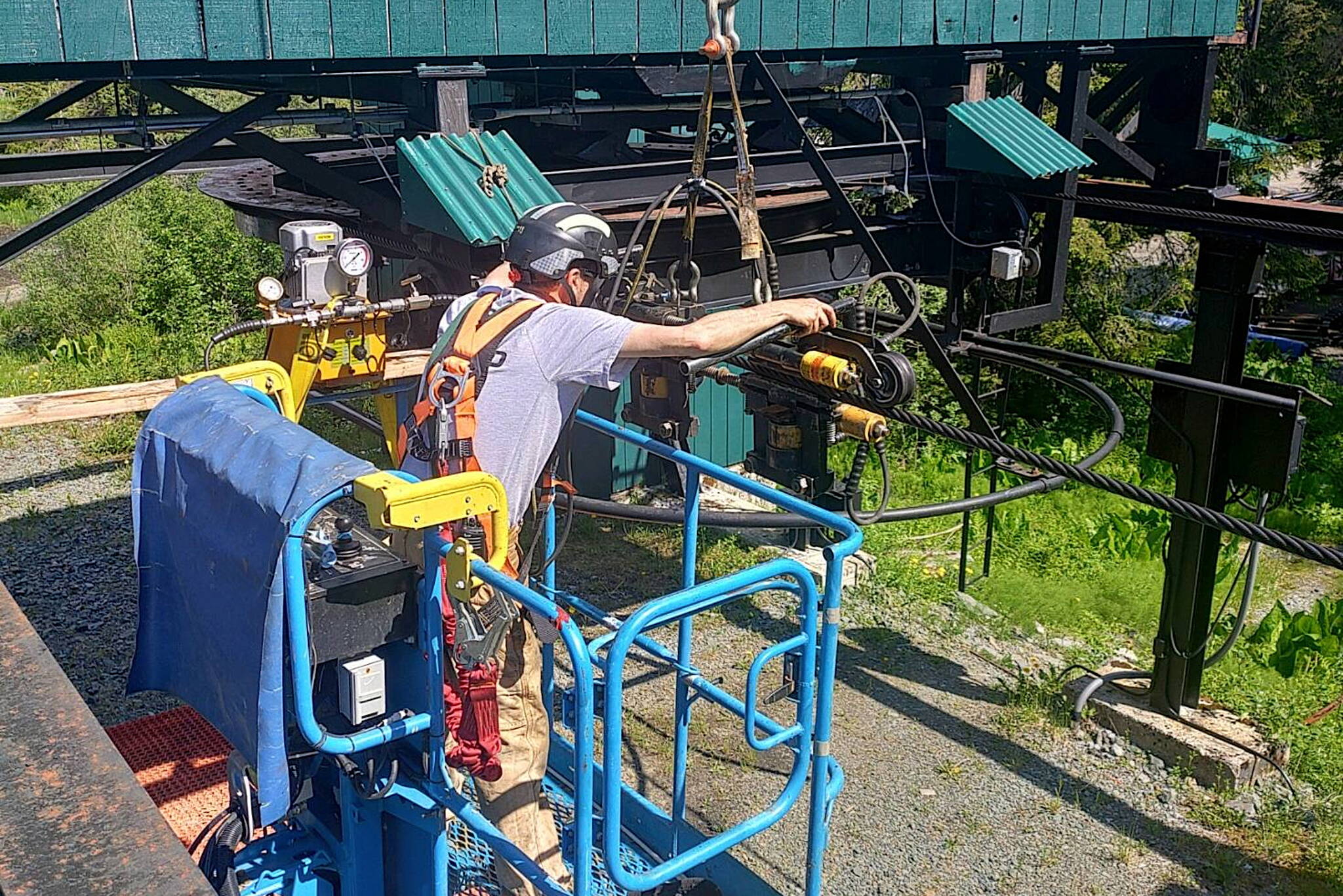 An employee performs maintenance work on a chairlift at Eaglecrest Ski Area in late June. (Eaglecrest Ski Area photo)
