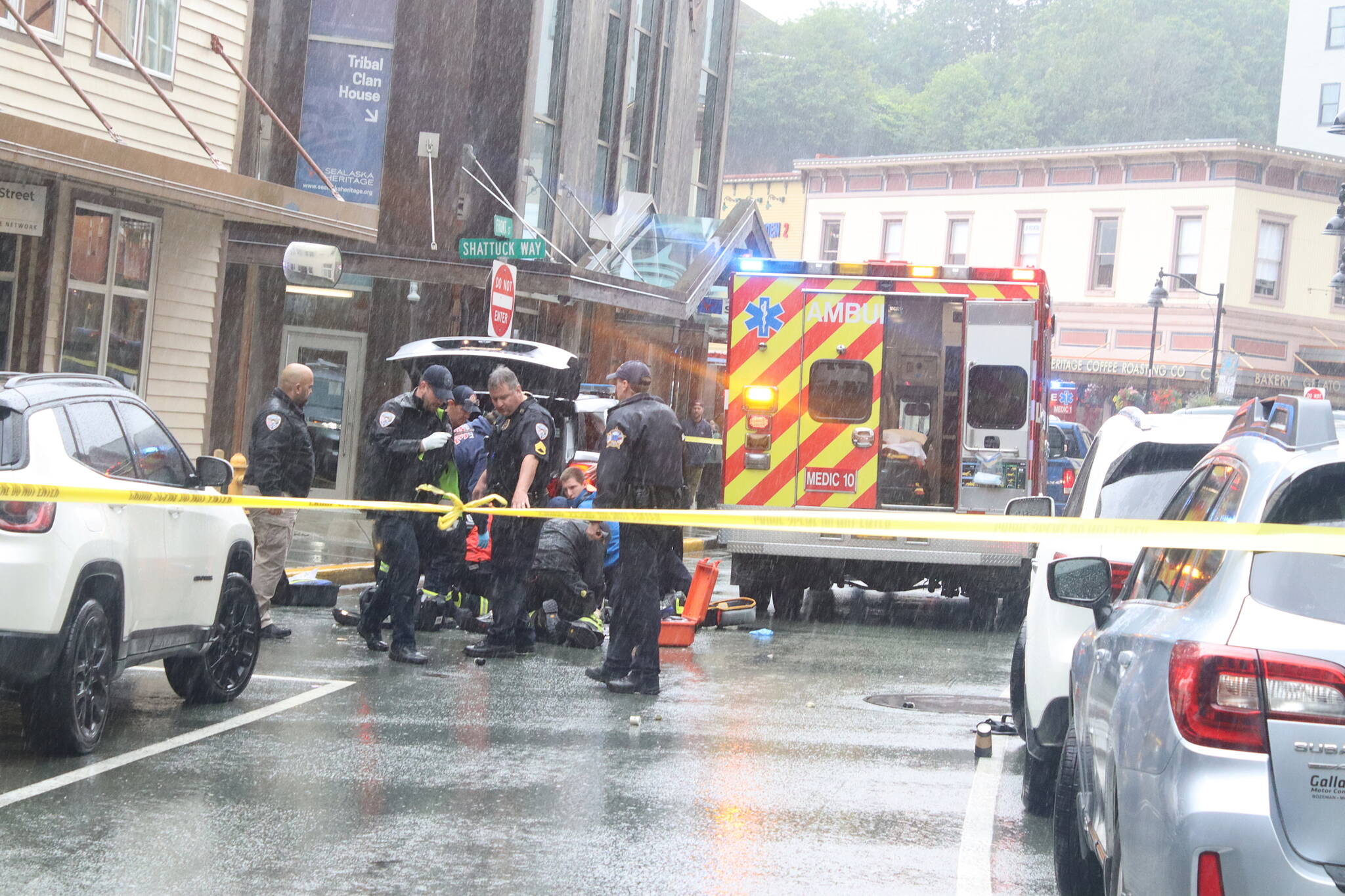 Police and other emergency officials treat Steven Kissack after he was shot on Front Street on Monday afternoon. (Mark Sabbatini / Juneau Empire)
