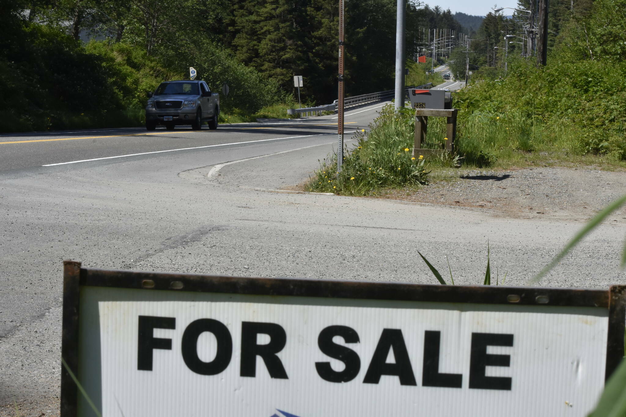 A sign on the Douglas Highway advertises a home for sale on Thursday, June 2, 2022. Home prices in Alaska have been increasing for the past two years but an expected increase to interest rates might cool off the market. (Peter Segall / Juneau Empire file photo)