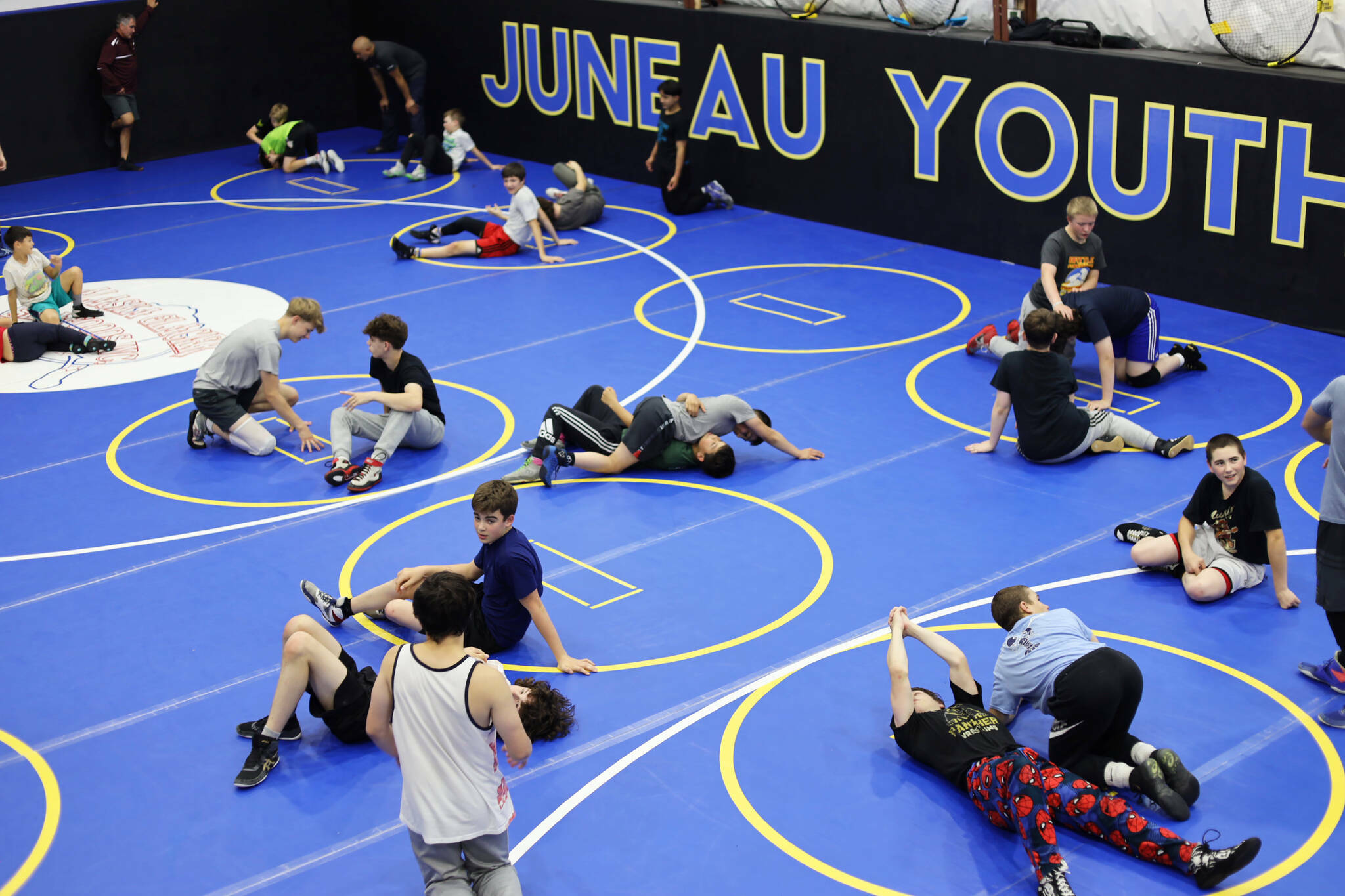 Athletes practice new moves while wrestling during a 2023 Labor Day weekend clinic at the Juneau Youth Wrestling Club. (Clarise Larson / Juneau Empire file photo)