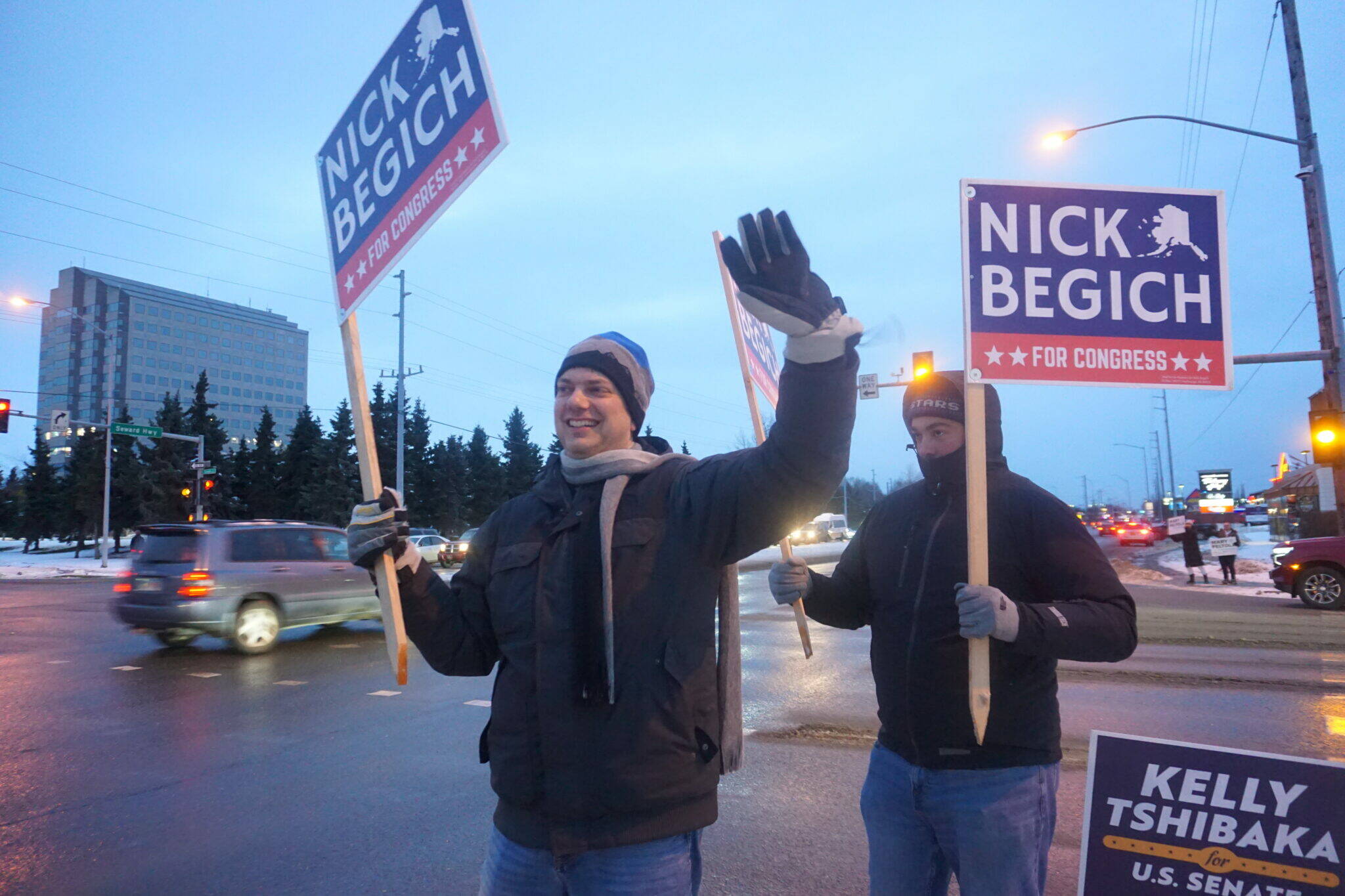 Republican U.S. House candidate Nick Begich, with sign-holding supporters, waves to Midtown Anchorage motorists on Election Day in 2022. (Yereth Rosen/Alaska Beacon)