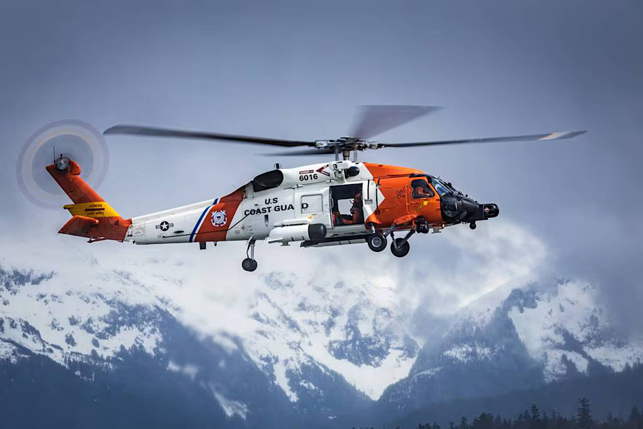 A U.S. Coast Guard Air Station Sitka helicopter hovers over Sitka Sound during routine hoist training on April 25, 2023. (Lt. Cmdr. Wryan Webb/U.S. Coast Guard)