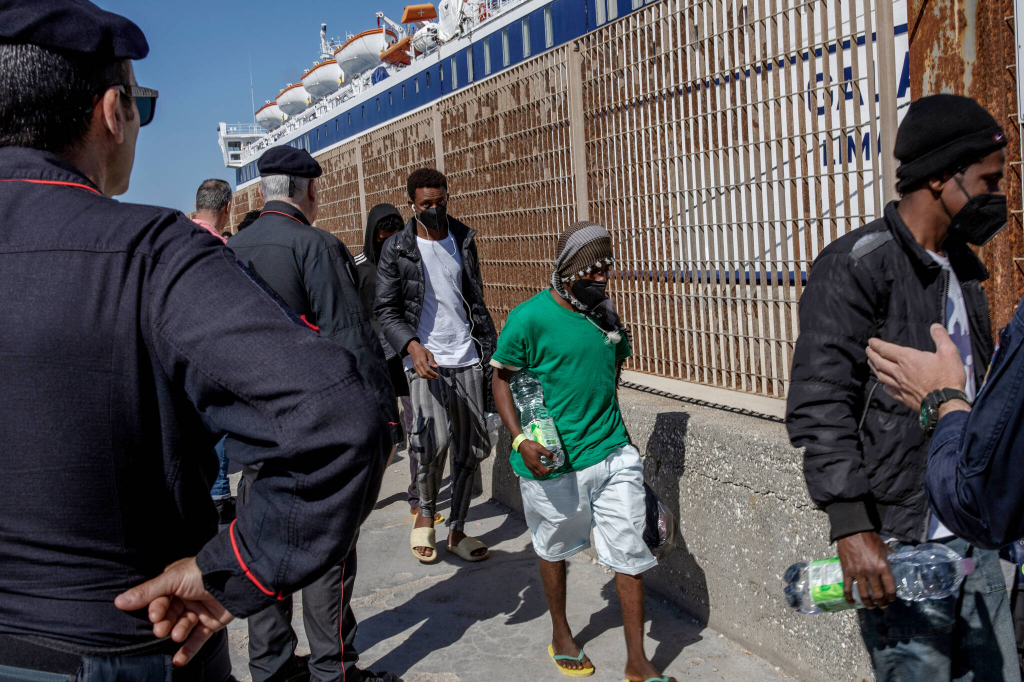 Detained migrants in Italy are moved onto a ferry bound for Sicily, May 4, 2023. (Fabio Bucciarelli/The New York Times)