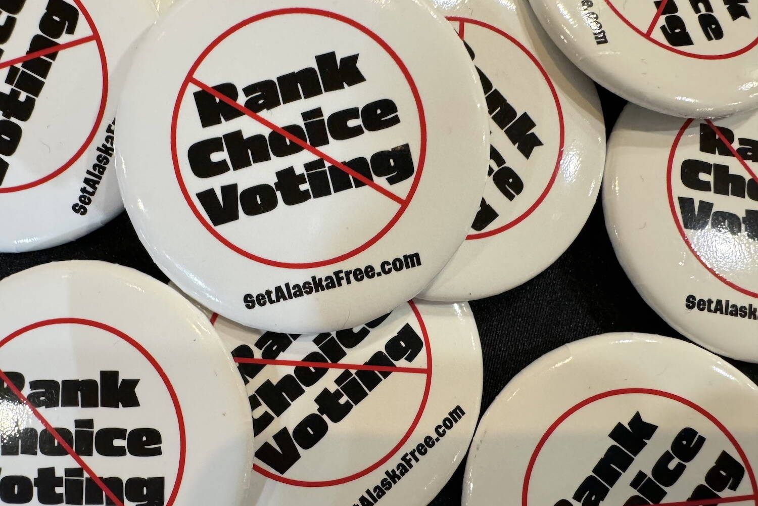 Pins supporting the repeal of ranked choice voting are seen on April 20, 2024, at the Republican state convention in Anchorage. (James Brooks/Alaska Beacon)