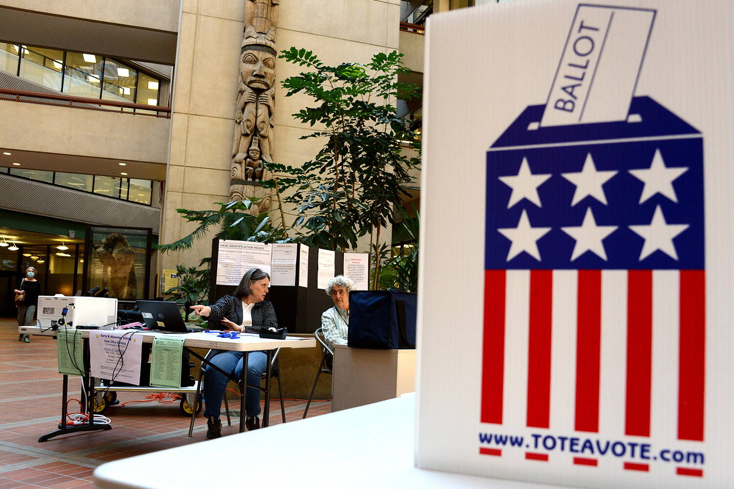 Volunteers operate an in-person polling place for the special U.S. House primary election on Friday, May 27, 2022 in the atrium of the State Office Building. (James Brooks/Alaska Beacon)