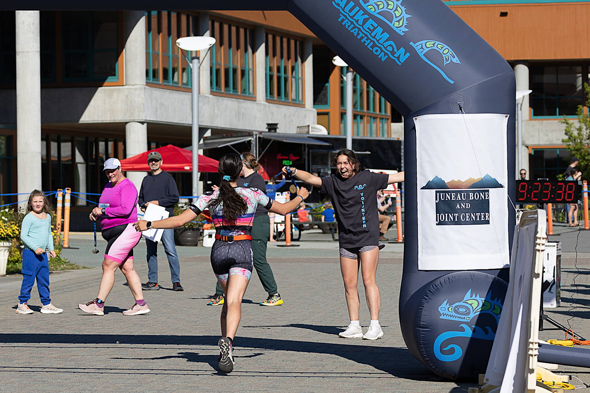 Isabella Lang gets an enthusiastic greeting as she finishes first overall in the Olympic distance in Aukeman Triathlon on Sunday. (Photo by Bob Eastaugh)