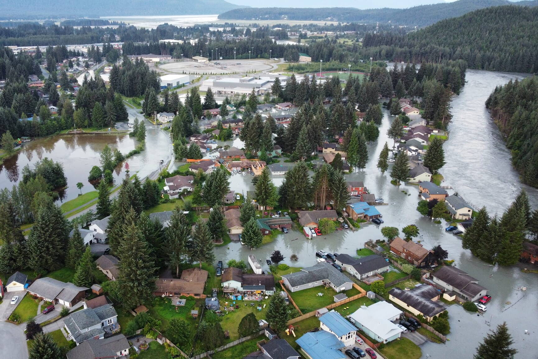 Homes, streets and vehicles are swamped by record flooding from the Mendenhall River on Tuesday morning. (Photo by Rich Ross)