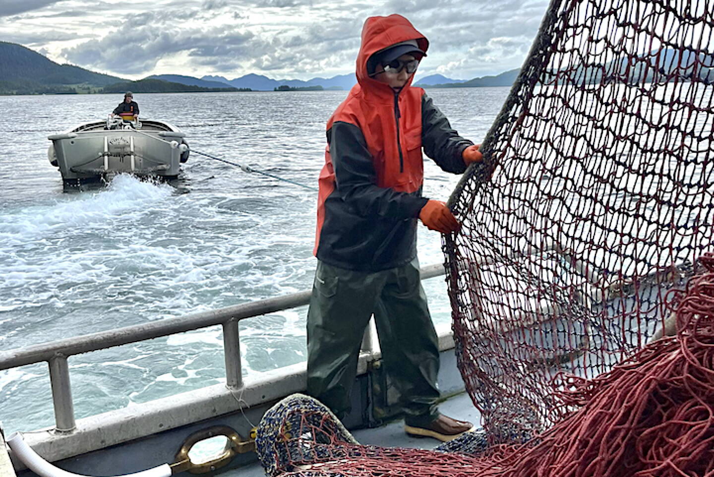 A crew member aboard a Prince William Sound works with the operator vessel’s skiff, which is used to maneuver the net into position. (Photo courtesy of Megan Corazza)