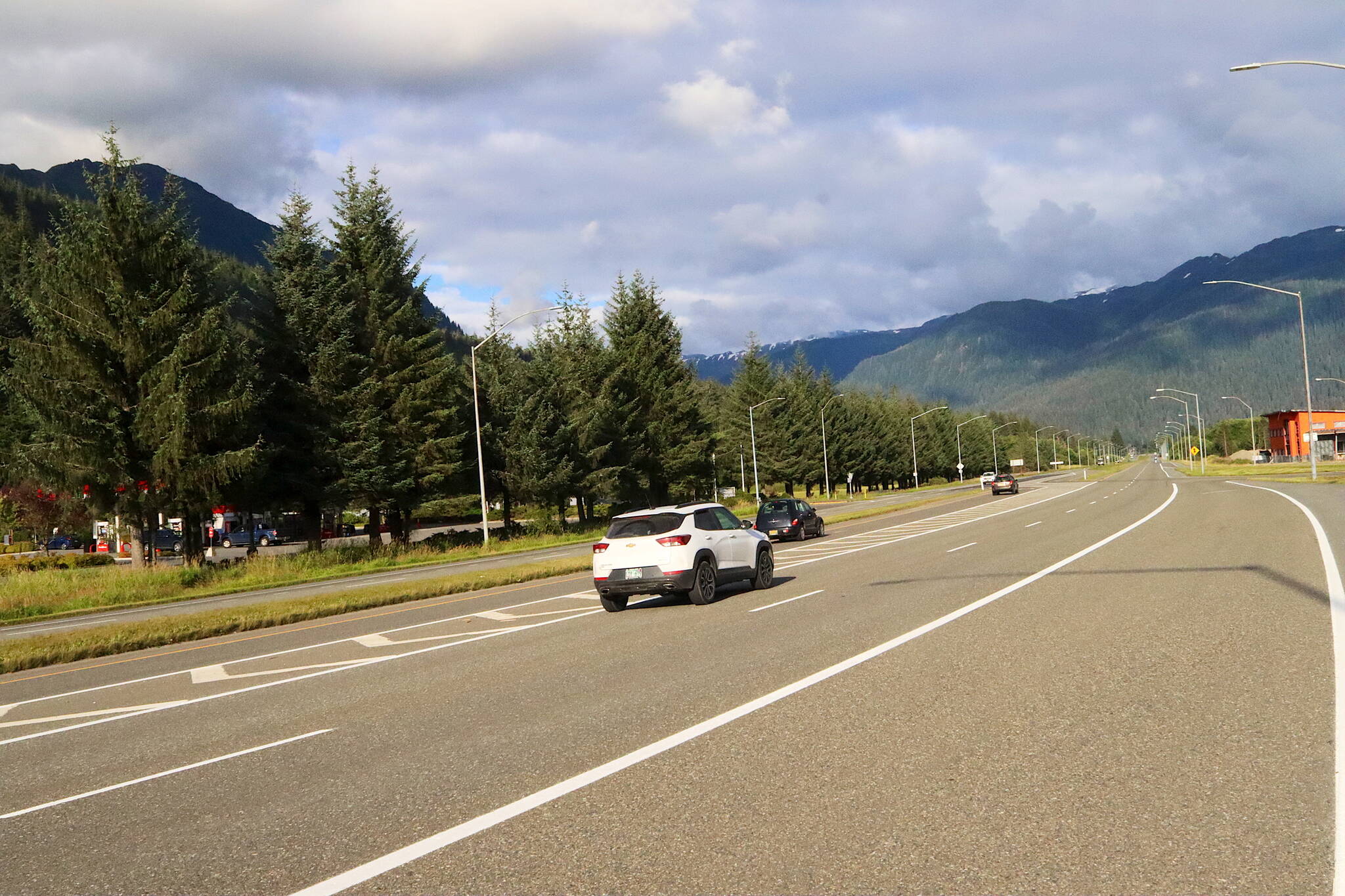 Cars enter a redesigned left-turn lane designed to improve the line-of-sight of drivers and reduce the distance necessary to cross Egan Drive at the Fred Meyer intersection on Monday. A traffic light on Egan Drive is scheduled to be installed at the intersection by 2027. (Mark Sabbatini / Juneau Enpire)