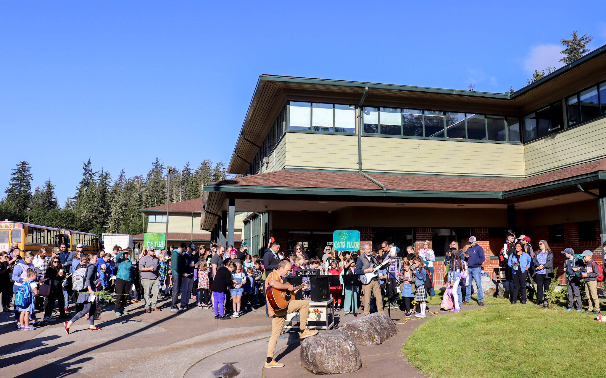 School buses arrive at the Dzantik’i Heeni campus on Thursday morning as Montessori Borealis Public Alternative School begins its 33rd annual “Wisdom Day.” (Jasz Garrett / Juneau Empire)