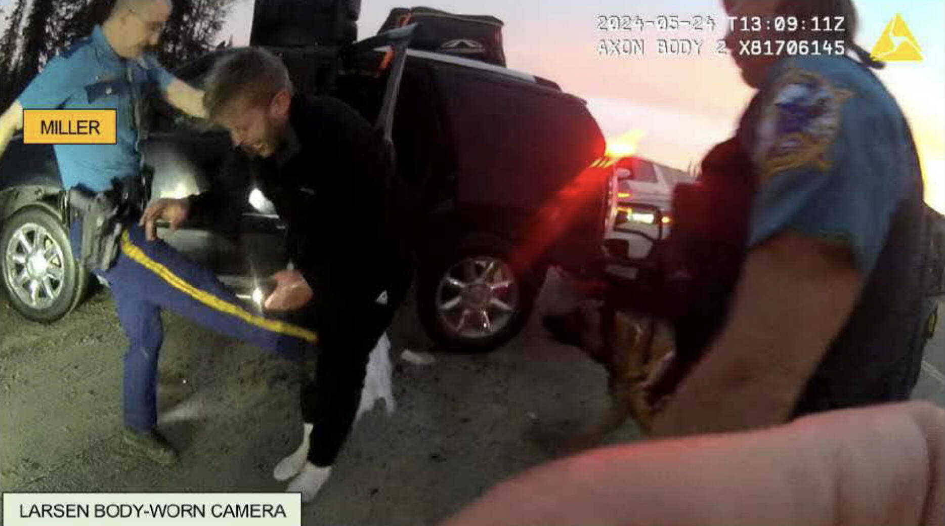 This screenshot from a body camera video was attached to criminal charging documents published Wednesday, Aug. 14, 2024, by the Alaska Department of Law. It shows an Alaska State trooper kicking a man in May 2024. The trooper and one other have been charged with misdemeanor assault. (Screenshot)