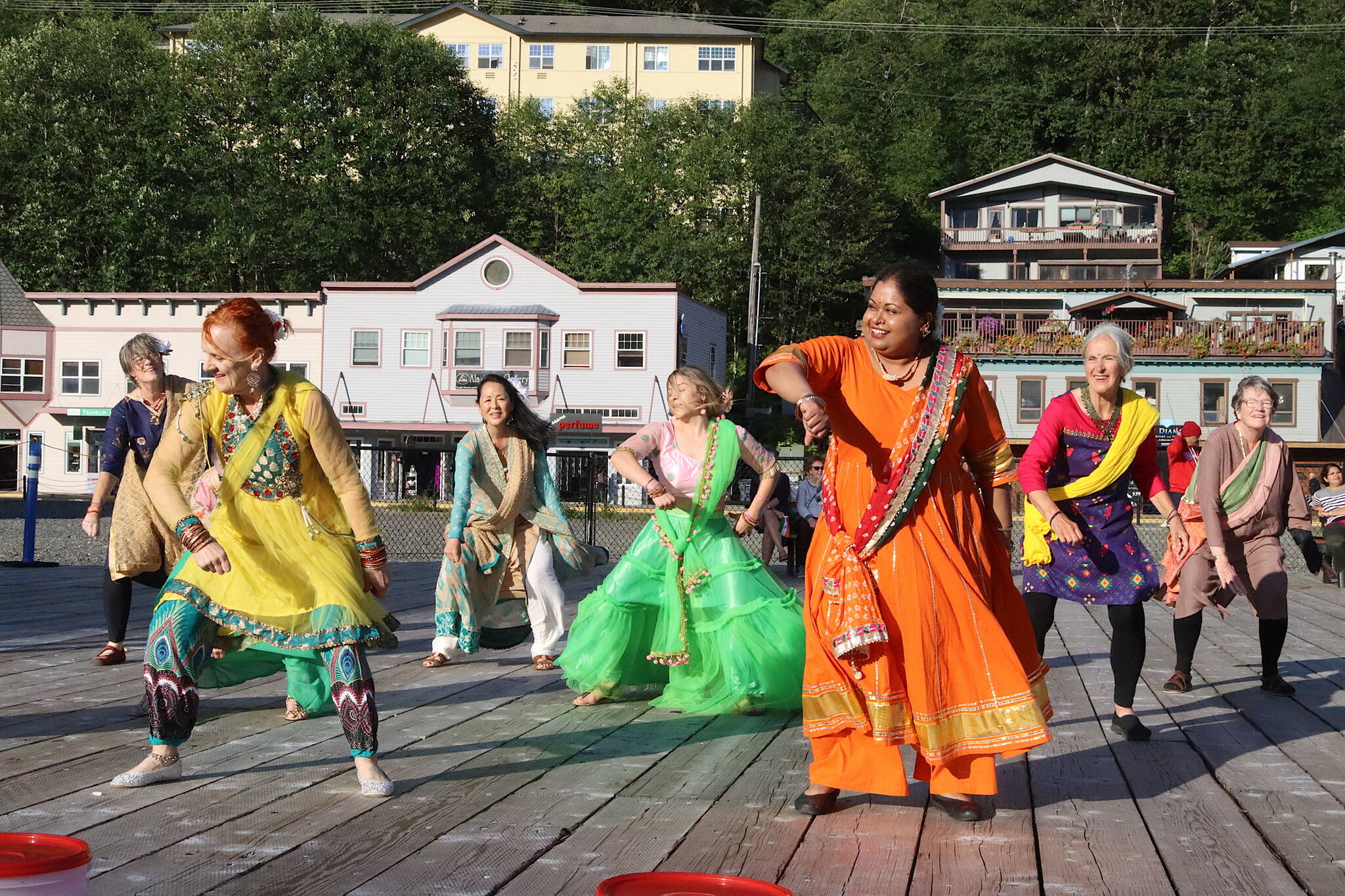 Nimmy Philips (wearing orange) leads a “Bollywood flash mob” during a celebration of India’s Independence Day on Friday at Elizabeth Peratrovich Plaza. The event was hosted by downtown businesses who presented a $10,000 donation to the Juneau Community Foundation to aid people affected by record flooding of the Mendenhall River earlier this month. (Mark Sabbatini / Juneau Empire)