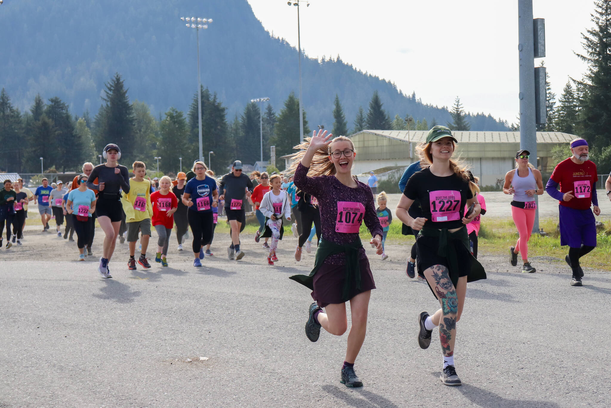 Ashley Murphy and Arianna Workman run toward the Kax̱dig̱oowu Héen Dei Trail in Cancer Connection’s 33rd annual Beat the Odds: A Race Against Cancer on Saturday. (Jasz Garrett / Juneau Empire)