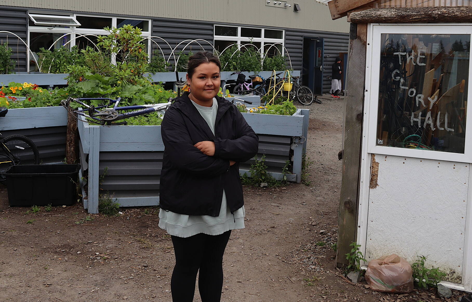 Kaia Quinto, the new executive director of the Glory Hall, stands in the garden of the shelter and soup kitchen on Monday. (Mark Sabbatini / Juneau Empire)