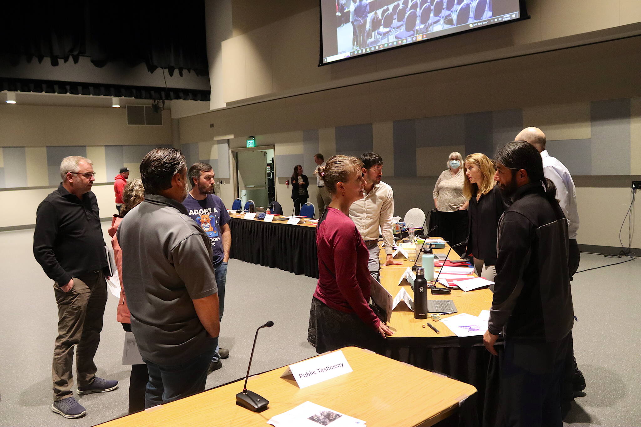 Residents talk to city leaders and other officials about the response to this year’s record flooding from Suicide Basin during a Juneau Assembly meeting Monday night at Centennial Hall. (Mark Sabbatini / Juneau Empire)