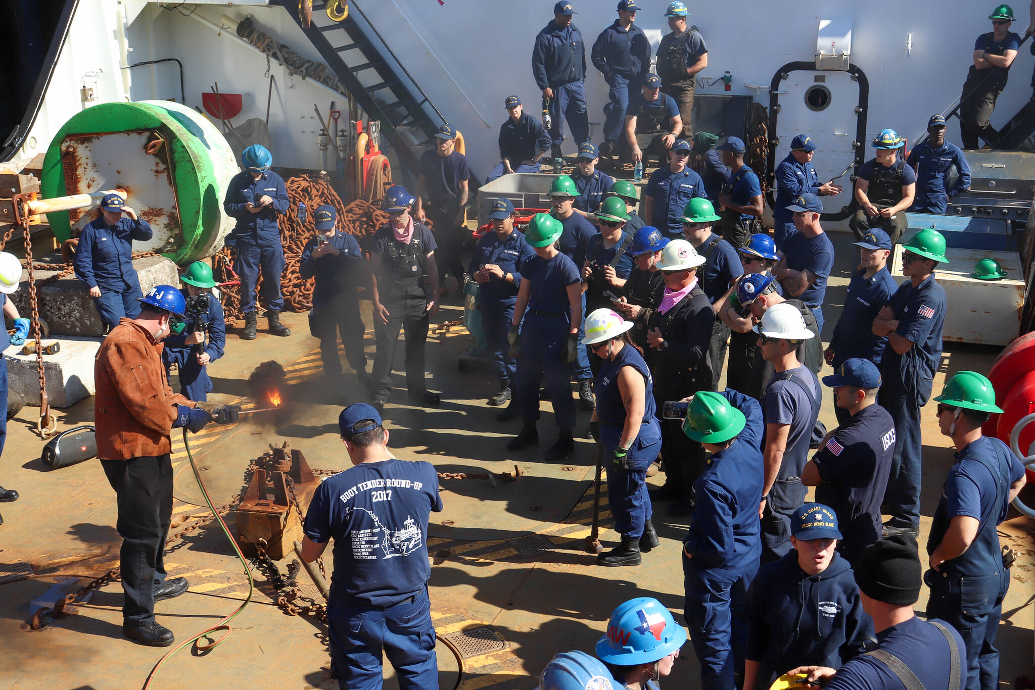 The U.S. Coast Guard participates in the annual heat-and-beat on Coast Guard cutter Kukui on Wednesday, a competition where teams from different cutters heat up a pin in order for it to be smashed down and sealed tightly. (Jasz Garrett / Juneau Empire)