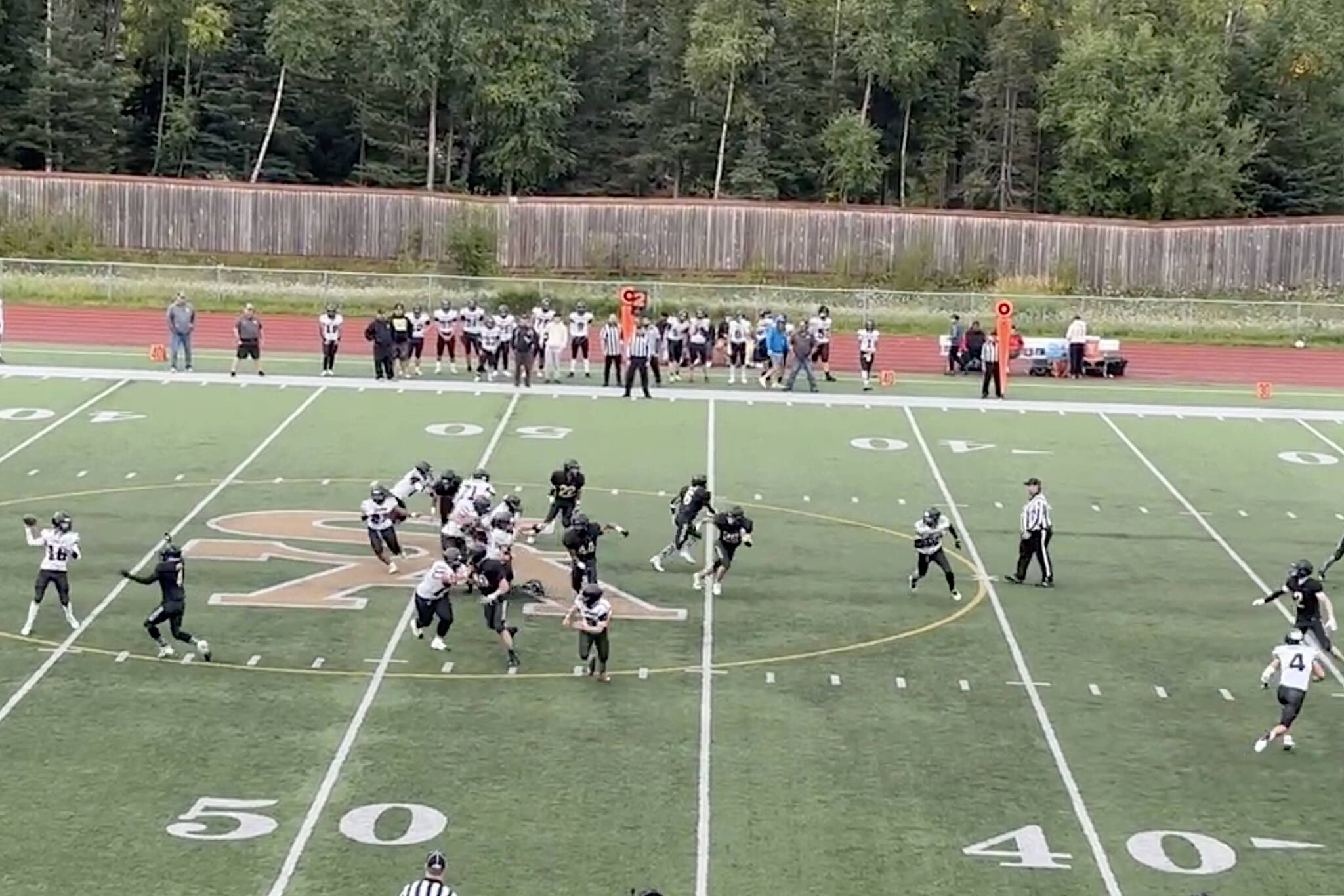 Caleb Ziegenfuss (left) looks to pass for the Juneau Huskies during Saturday’s road game against South Anchorage High School. (Screenshot from Juneau Huskies Football livestream)