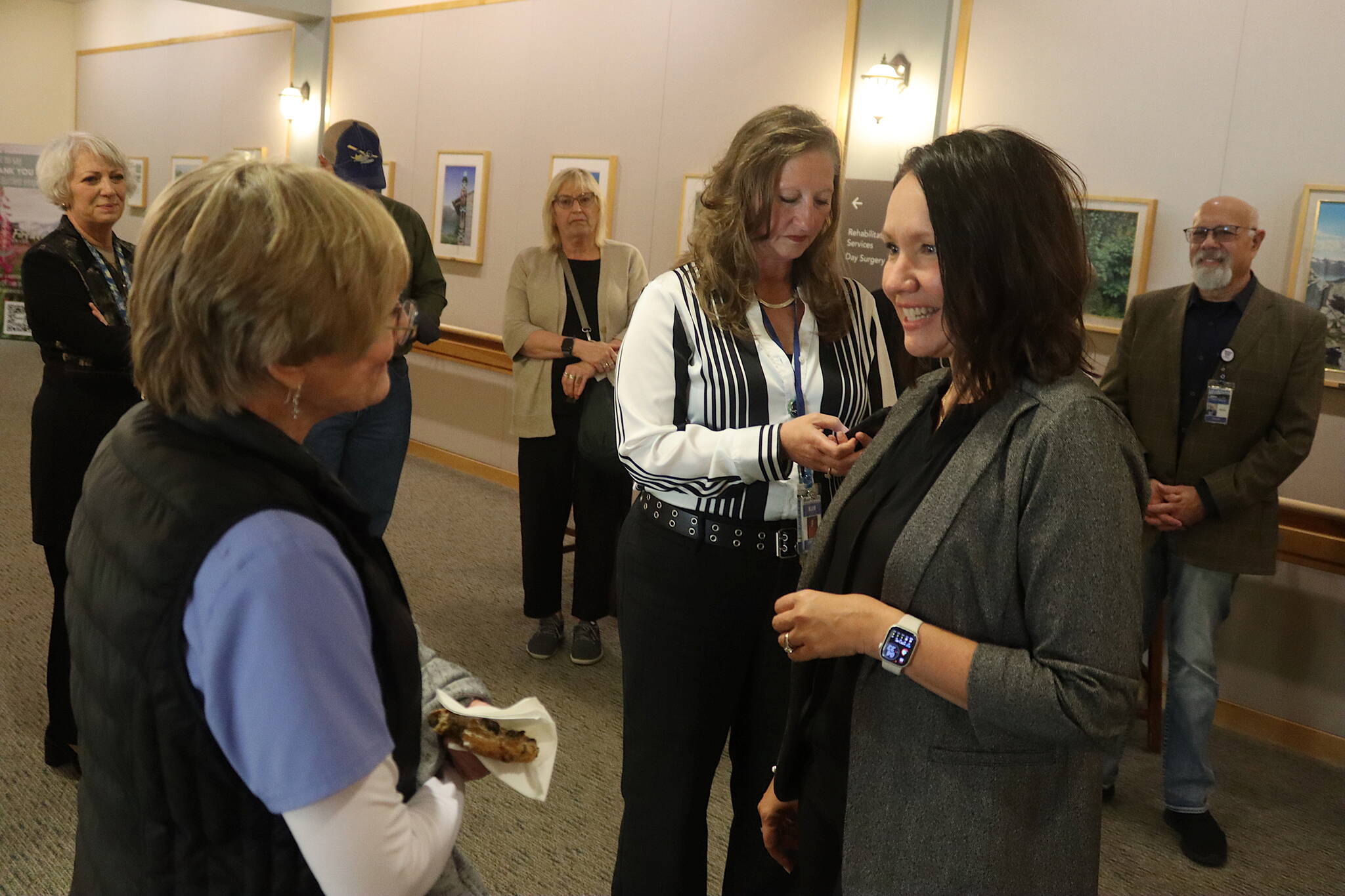 Melanee Tiura (right), one of three finalists to be the new CEO at Bartlett Regional Hospital, talks with an employee during a meet-and-greet at the hospital on Aug. 26. (Mark Sabbatini / Juneau Empire)