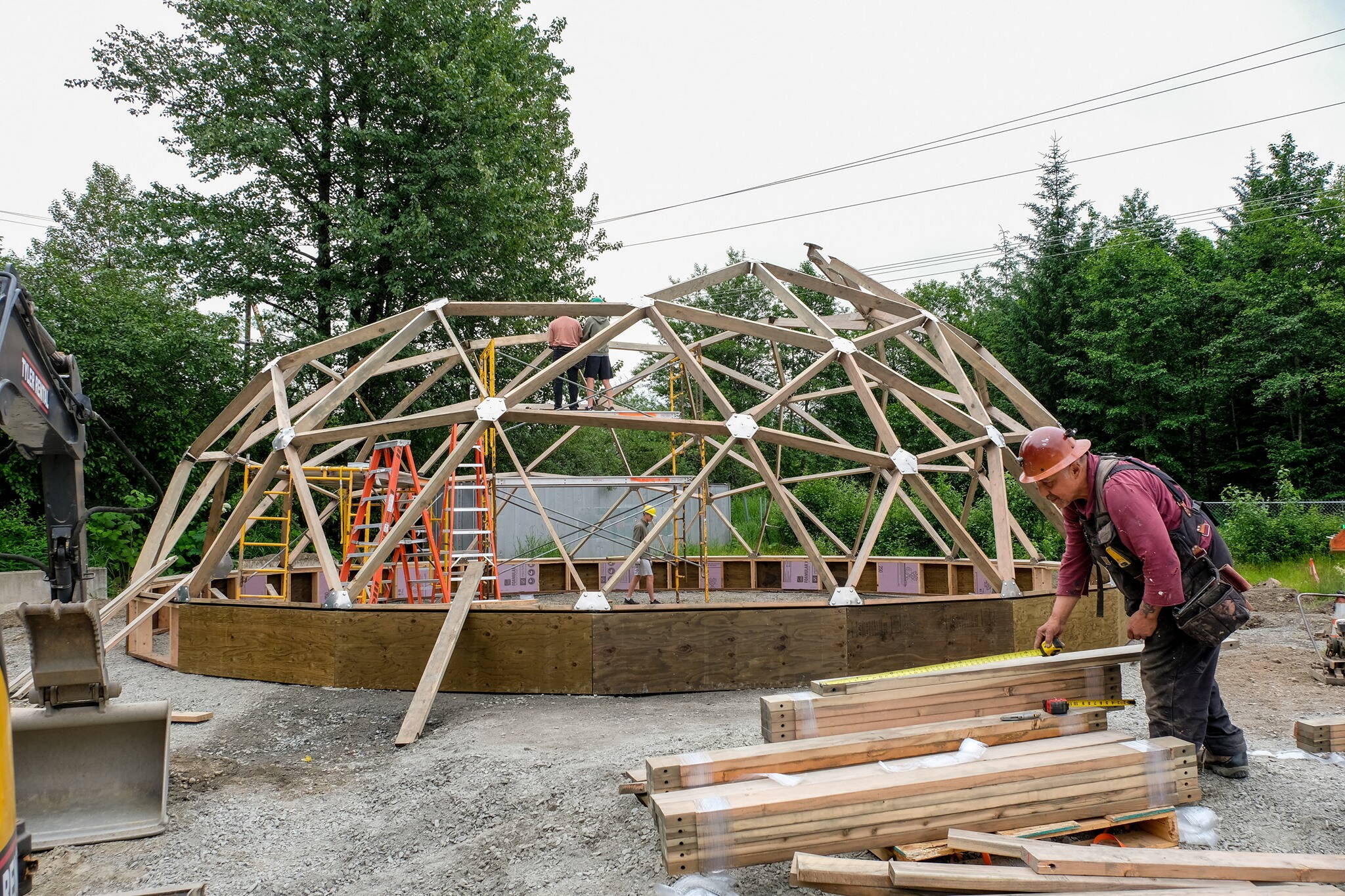 Workers construct a greenhouse behind the Edward K. Thomas building during the summer of 2021. The greenhouse is part of a food sovereignty project by the Central Council of the Tlingit and Haida Indian Tribes of Alaska, which this week received a $15 million grant from the U.S. Environmental Protection agency to establish or expand composting operations in five Southast Alaska communities including Juneau. (Central Council of the Tlingit and Haida Indian Tribes of Alaska photo)