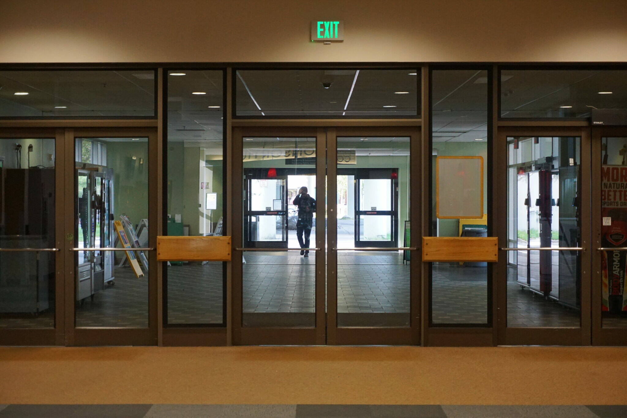 A student exits the University of Alaska Anchorage consortium library on Friday. Alaska now has had 12 years of net outmigration, with more people leaving the state than moving in, contrary to past history when Alaska drew large numbers of young adults. (Yereth Rosen/Alaska Beacon)