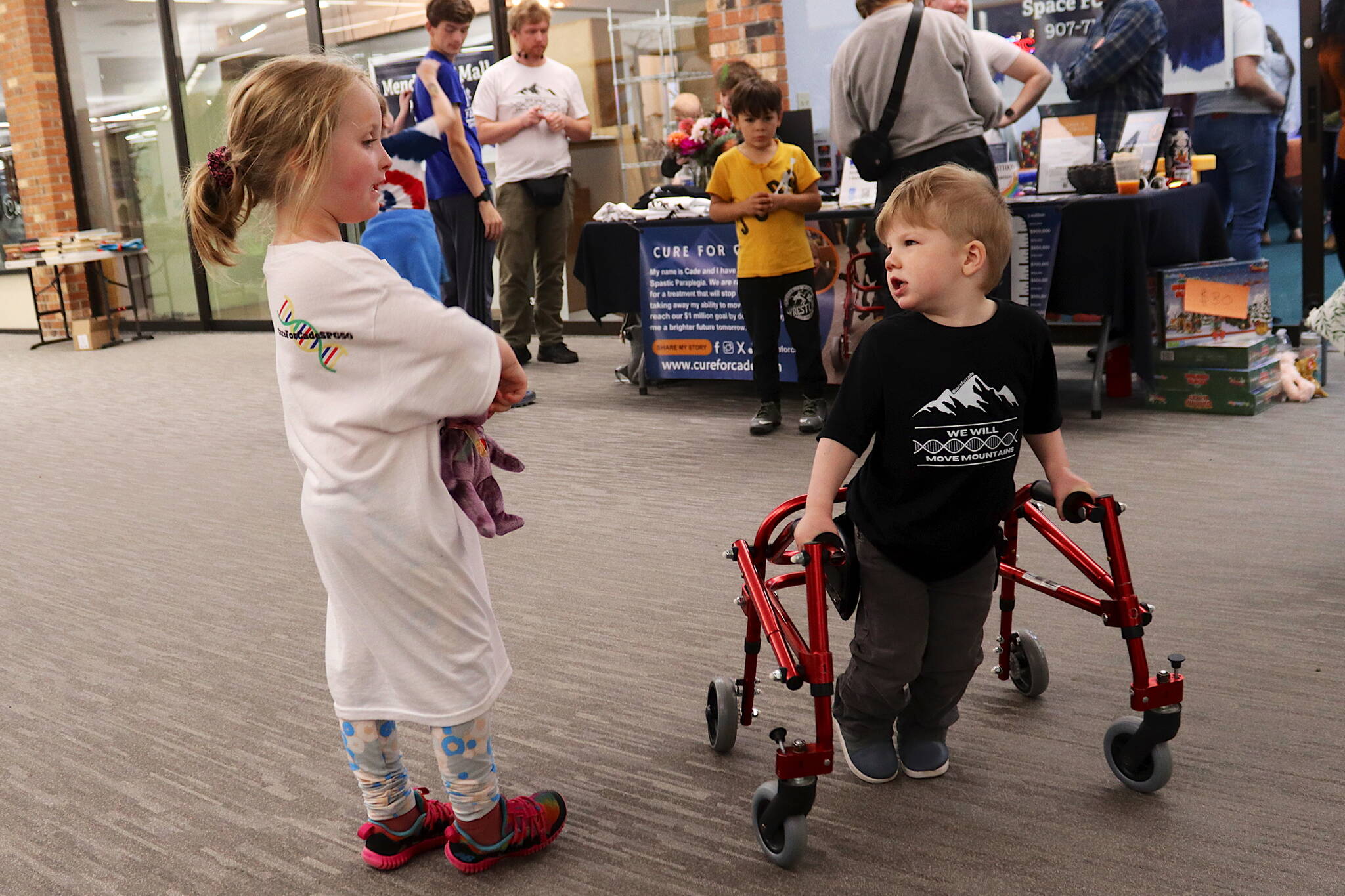 Mark Sabbatini / Juneau Empire
Lily Weed, 4, visits with Cade Jobsis, 3, during a walkathon Saturday at the Mendenhall Mall to raise funds for treatment for a rare genetic disorder he has.