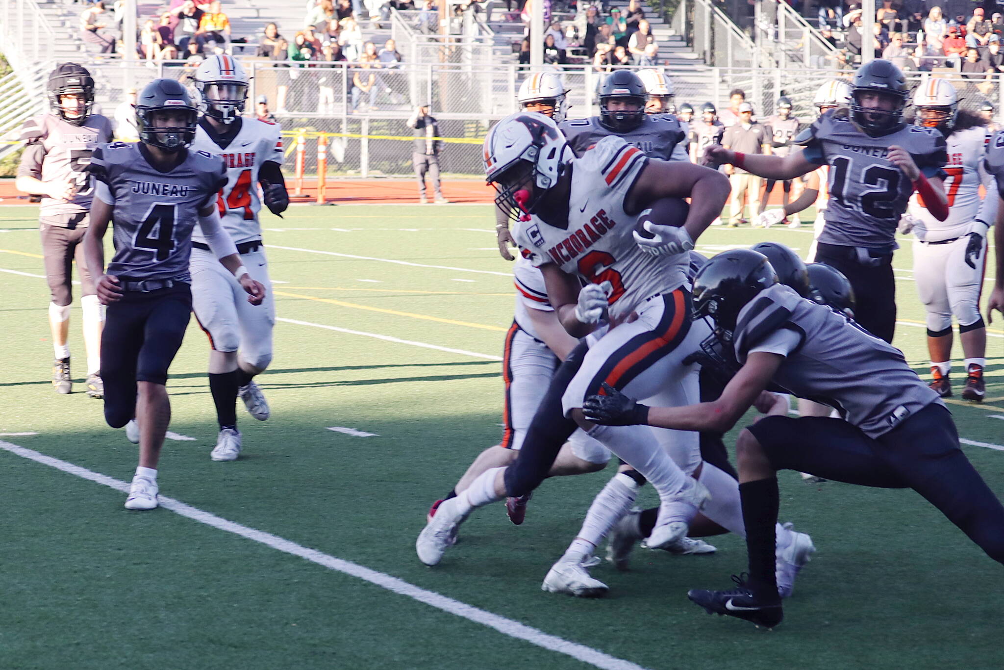 West Anchorage High School’s Zephaniah Sailele (6) breaks through Juneau defenders during Saturday’s game at Adair-Kennedy Memorial Park. (Mark Sabbatini / Juneau Empire)