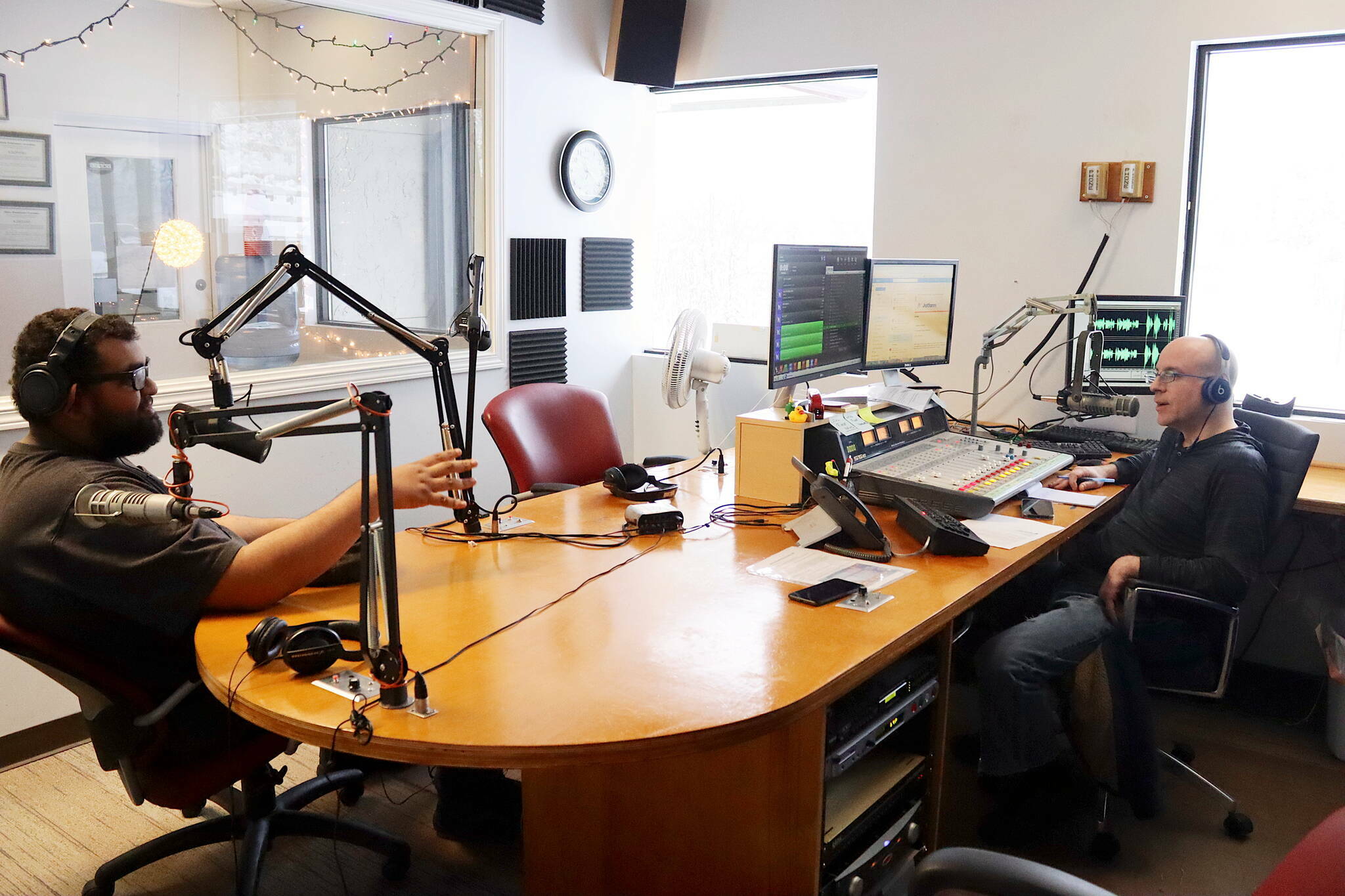 Jordan Lewis (left), former news director for Local First Media Group, and Wade Bryson discuss the day’s top stories during the final live broadcast of KINY-AM’s “Problem Corner” on Friday, Feb. 2, 2024, before it was halted by the station. KINY is reviving the program weekdays with longtime on-air employee Mike Lane as the primary host beginning at 1 p.m. Monday. (Mark Sabbatini / Juneau Empire file photo)