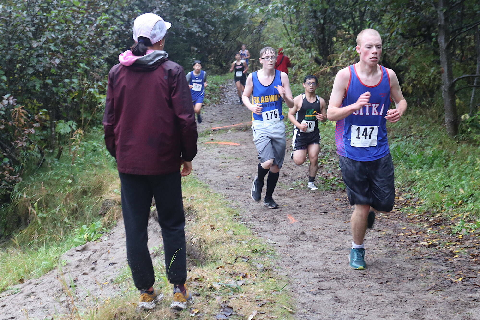 Boys from high schools throughout Southeast Alaska run along the Treadwell Mine Historic Trail during the Capital City Invite 5K last Saturday. (Mark Sabbatini / Juneau Empire file photo)