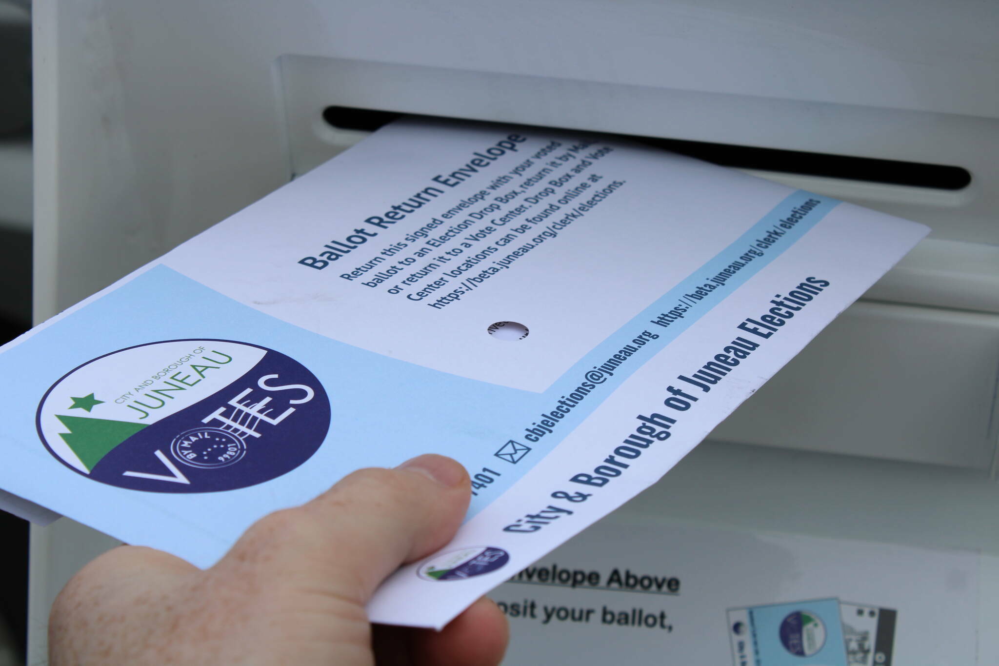 A local-mail in ballot is deposited in a drop box. (Ben Hohenstatt / Juneau Empire file photo)