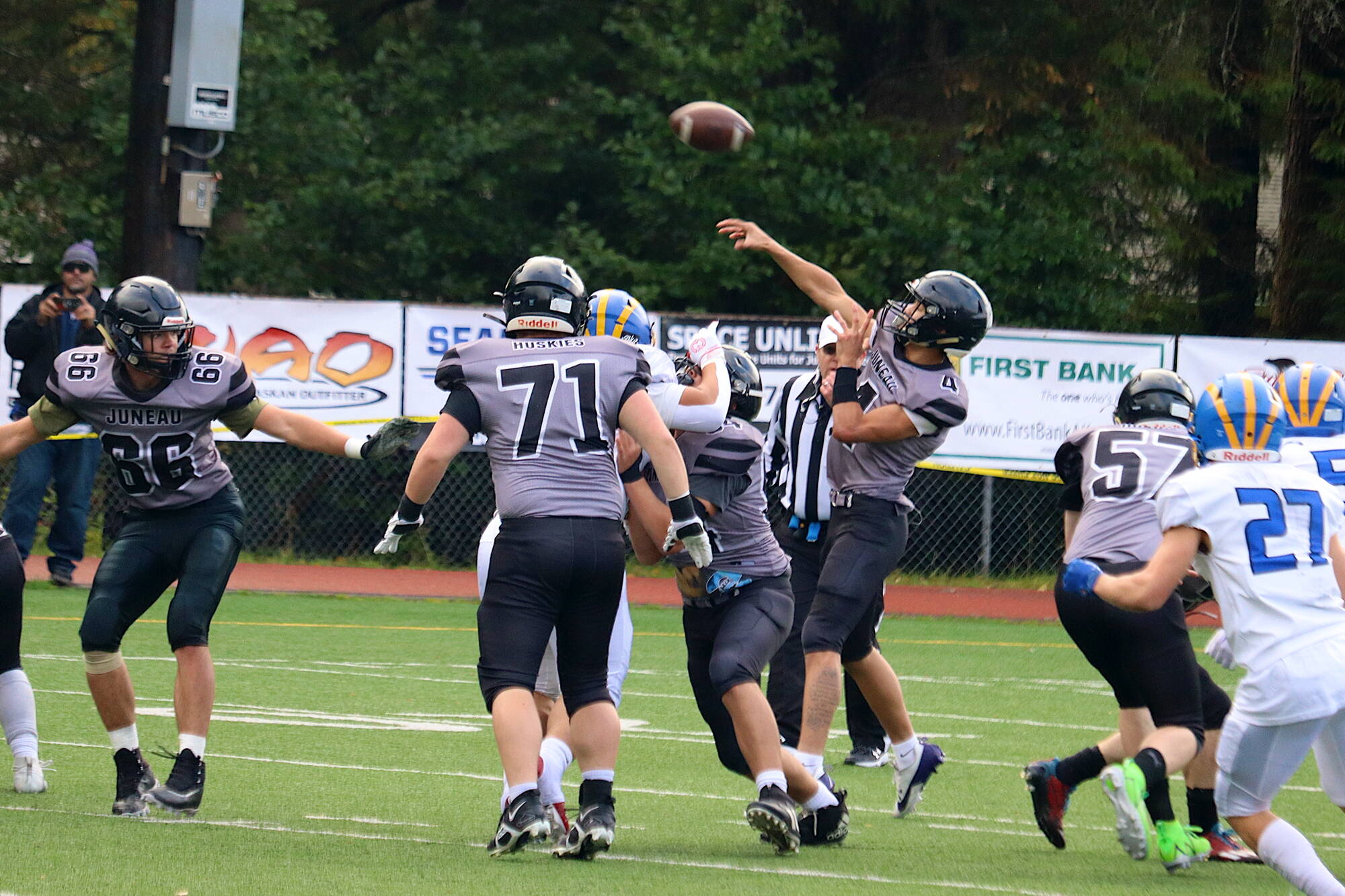 Jayden Johnson (4) throws a pass for Juneau-Douglas High School: Yadaa.at Kalé in the first quarter of Saturday’s game against Bartlett High School at Adair-Kennedy Memorial Park. Johnson, a senior wide receiver, played nearly the entire game at quarterback. (Mark Sabbatini / Juneau Empire)