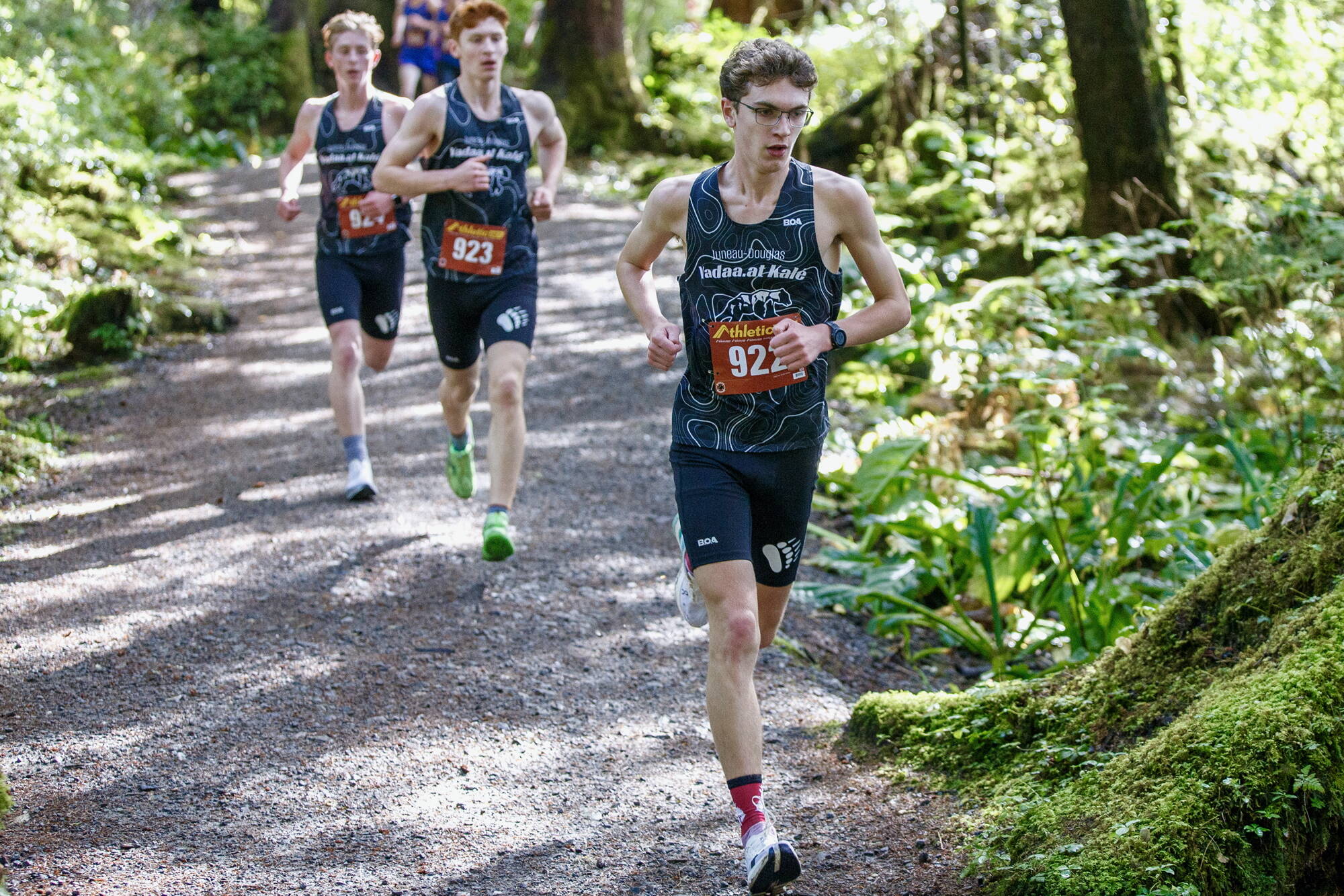 Juneau-Douglas High School: Yadaa.at Kalé’s Nick Iverson leads his teammates Erik Thompson and Owen Woodruff as they take first, second and third place in the Men’s 5,000-meter race during the Division 1 Region V Cross Country meet at Ward Lake in Ketchikan on Saturday, Sept. 28, 2024. Iverson won the event with at time of 16:27.11. (Christopher Mullen/ Ketchikan Daily News)